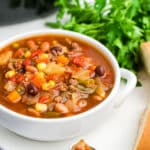 A white bowl filled with crockpot cowboy soup.