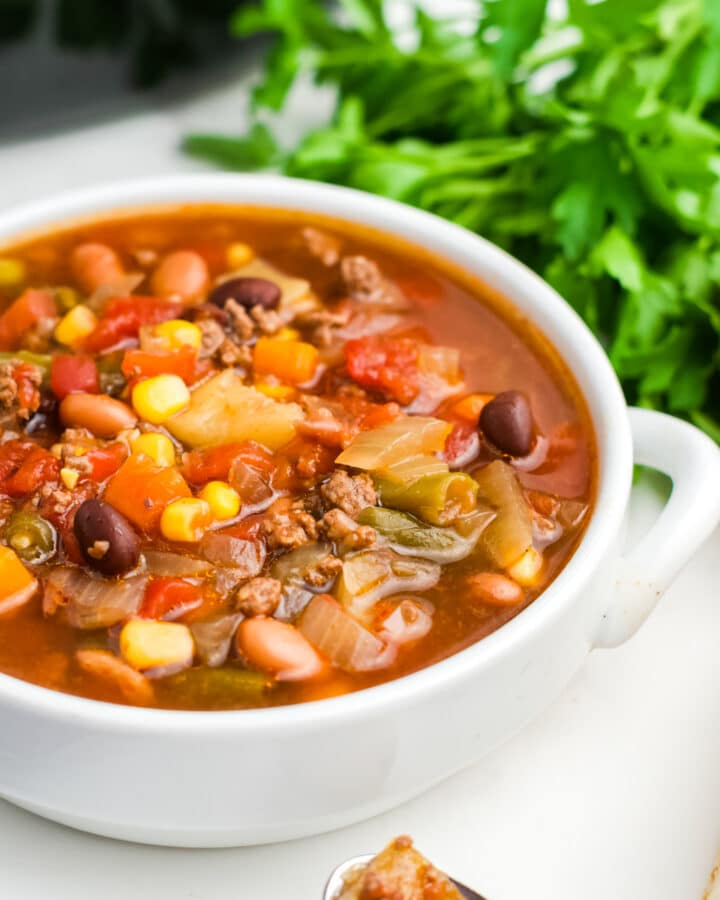 A white bowl filled with crockpot cowboy soup.