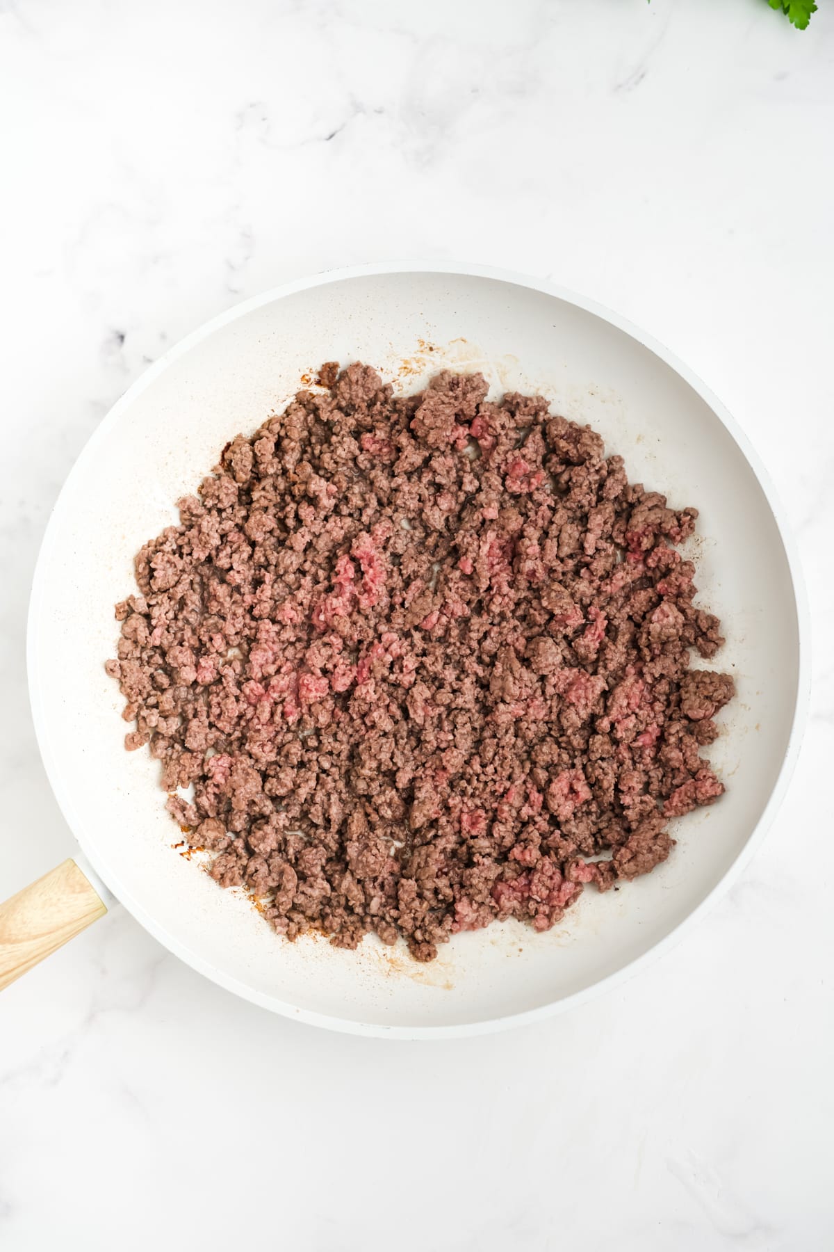 Ground beef in a skillet.