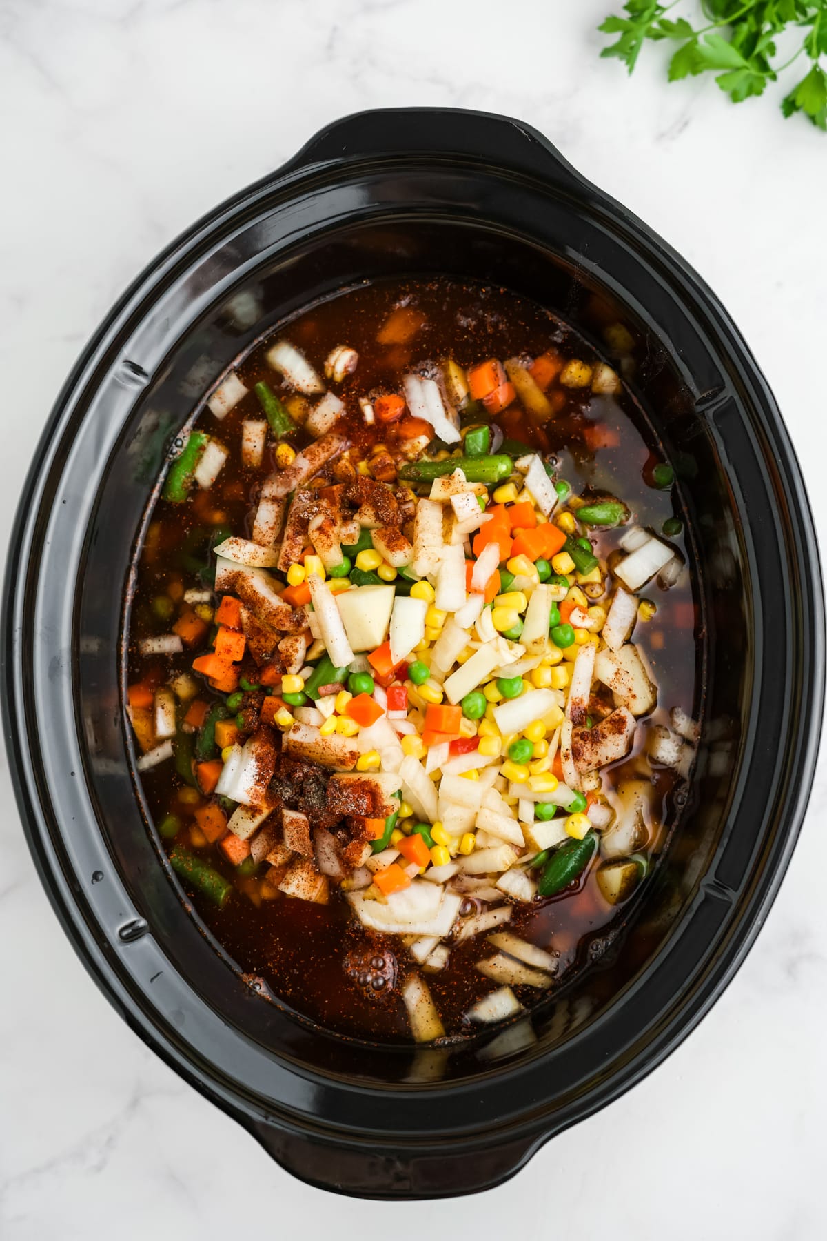 All of the uncooked ingredients for this soup in the slow cooker.