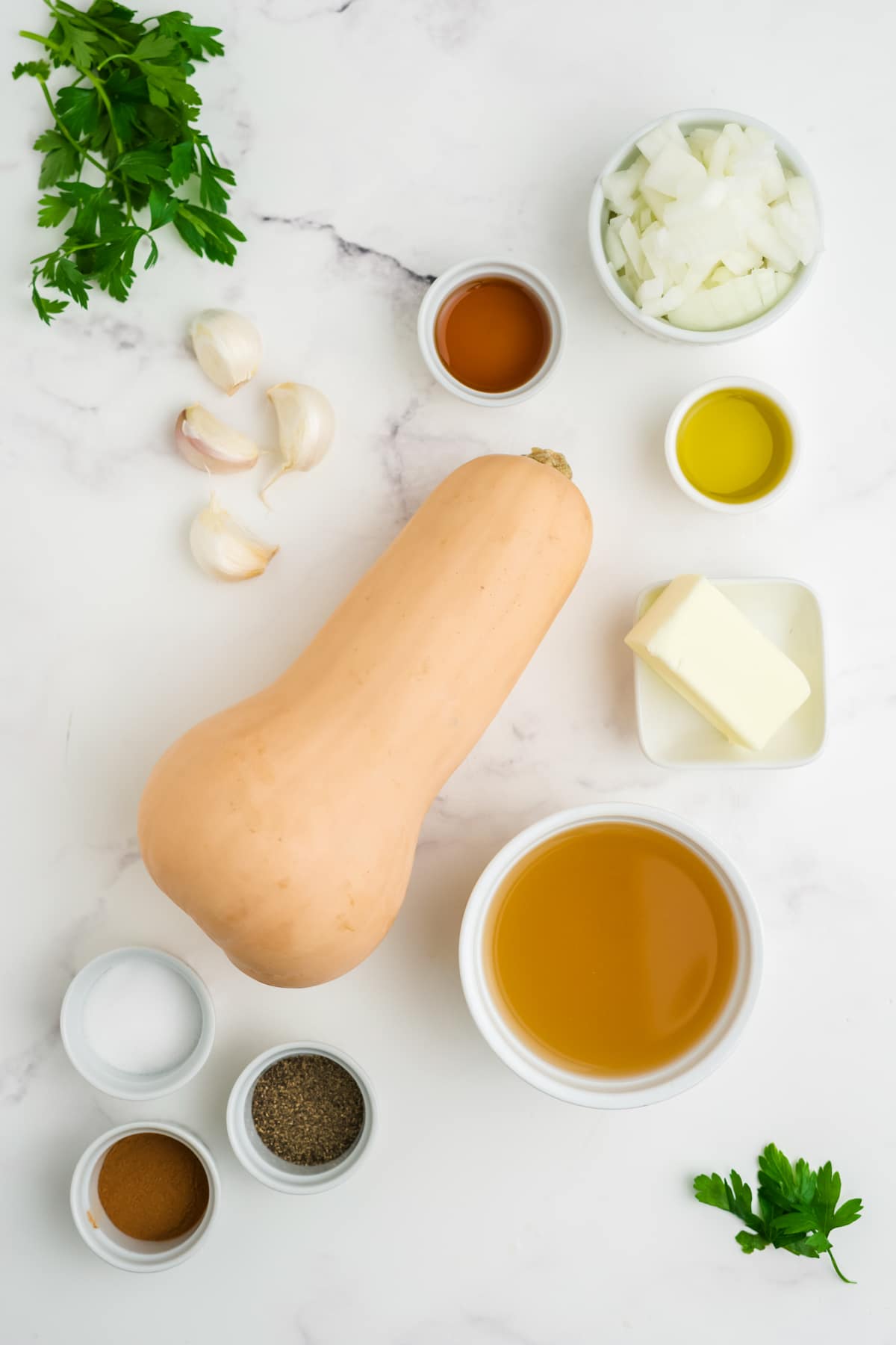 Ingredients for making butternut squash soup on a counter.