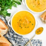 Bowls of roasted butternut squash soup on a table.
