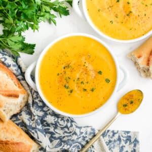 Bowls of roasted butternut squash soup on a table.