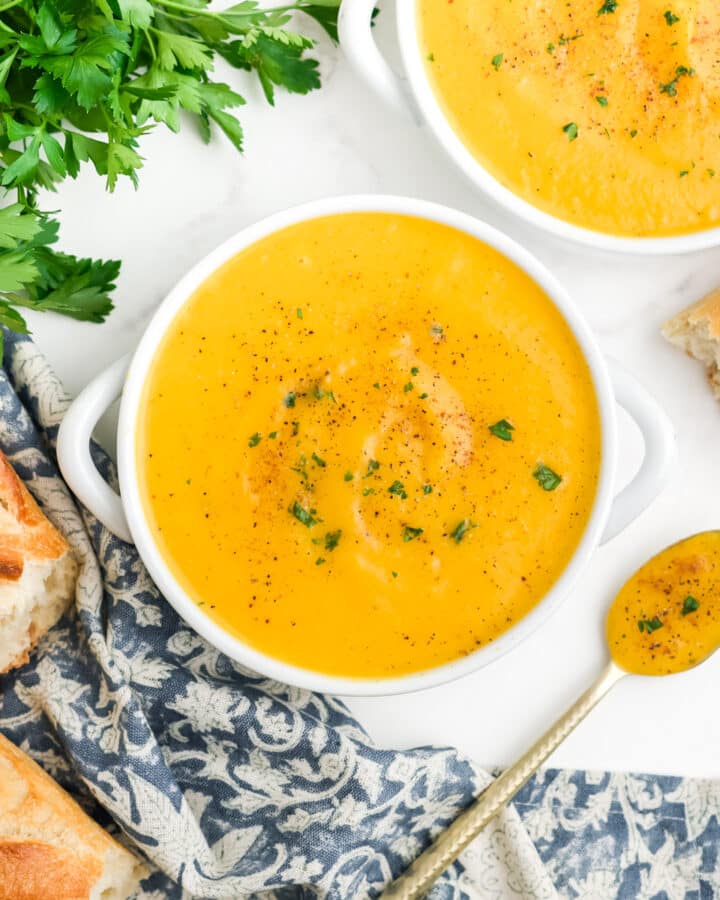 Bowls of roasted butternut squash soup on a table.