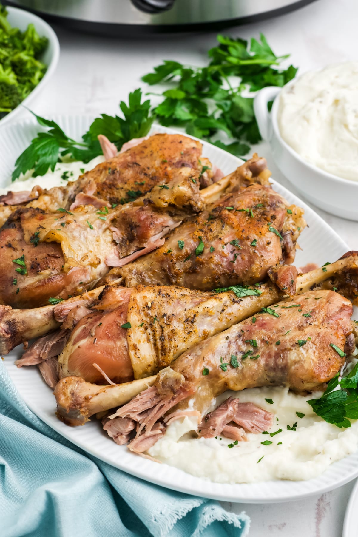 Slow cooker turkey legs on a serving dish.