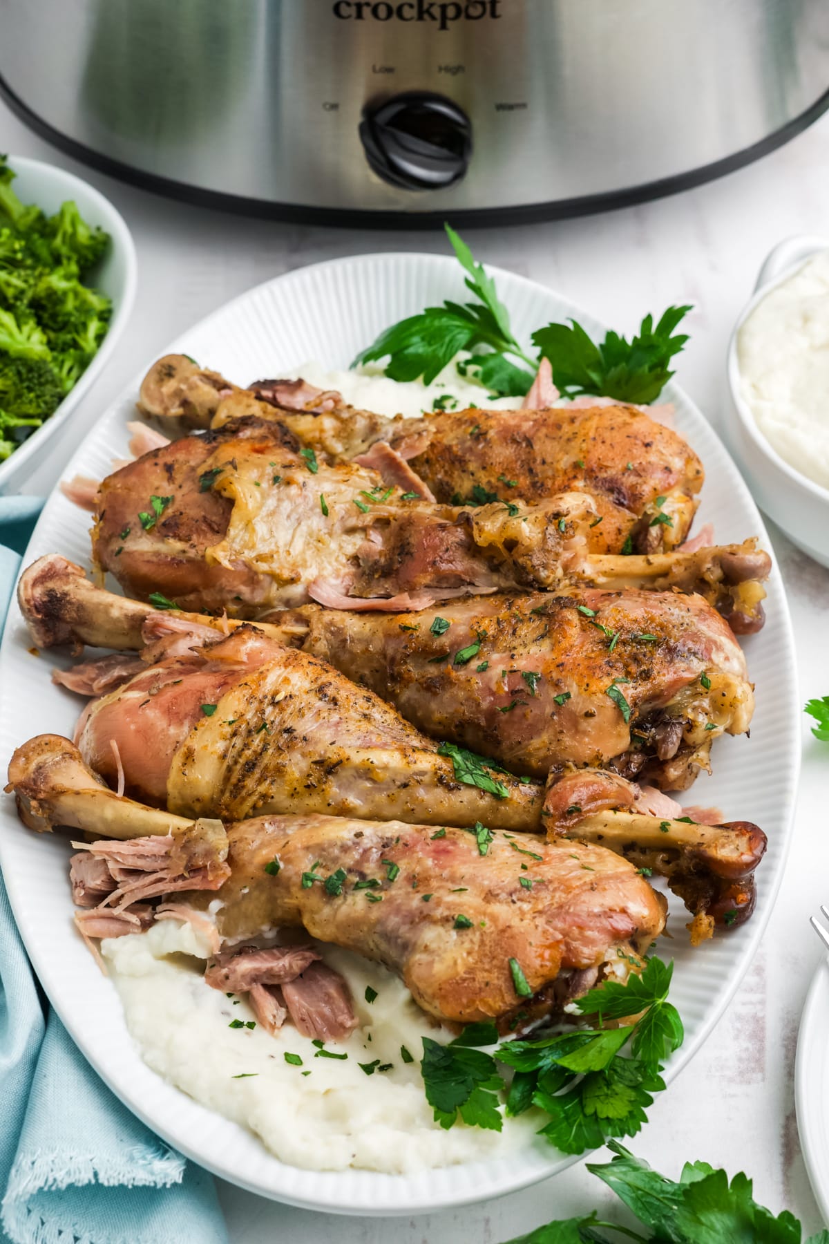 Slow cooker turkey legs on a serving dish.