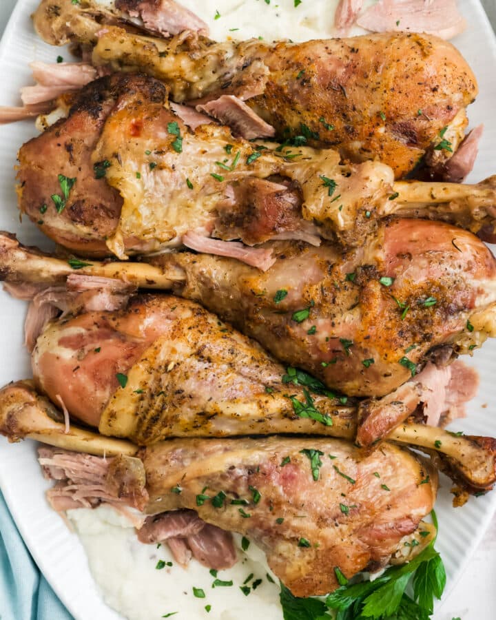 Slow cooker turkey legs on a serving dish.