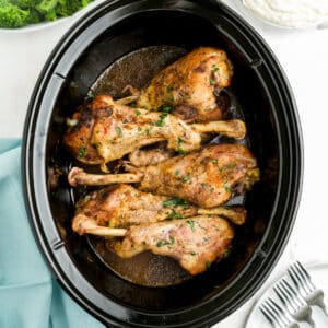 Turkey legs in a slow cooker ready to serve.