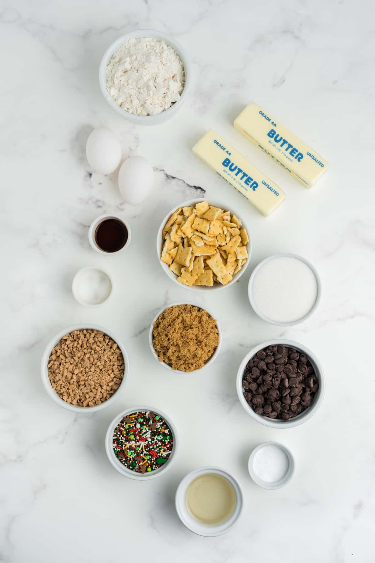 Ingredients for making Christmas crack cookies in bowls.