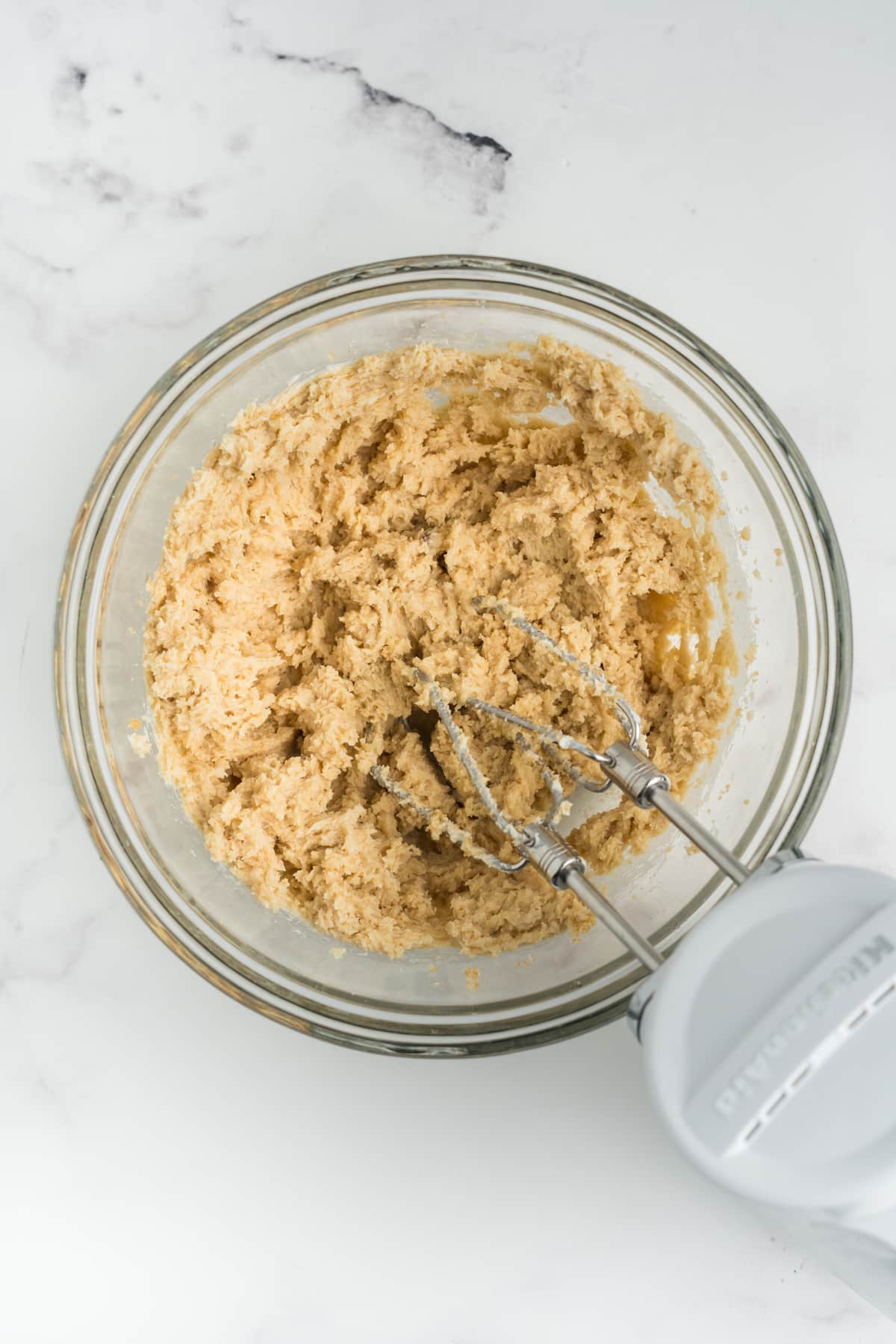 Butter and sugar creamed together in a bowl.