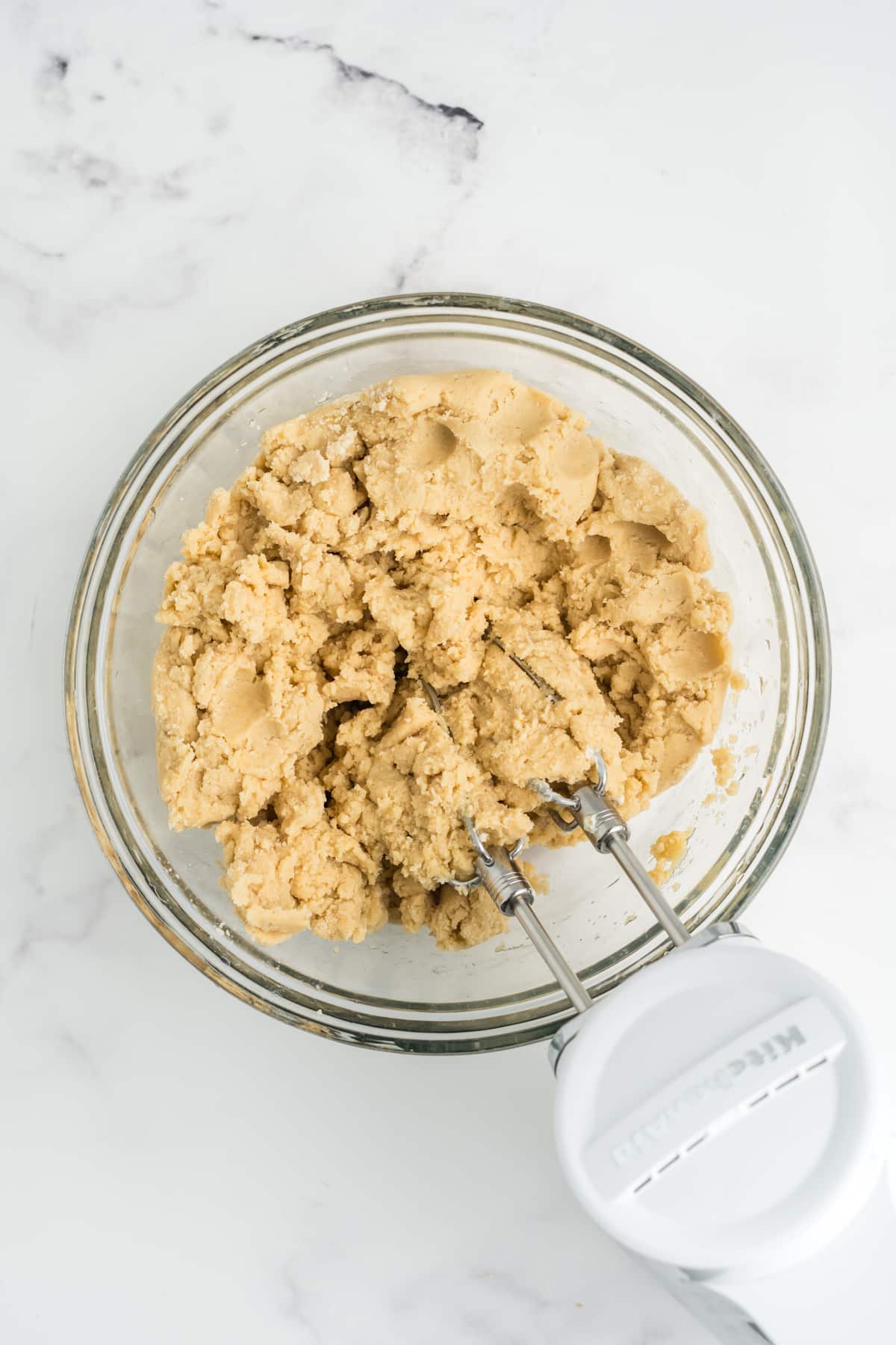 The wet and dry ingredients combined in a mixing bowl.