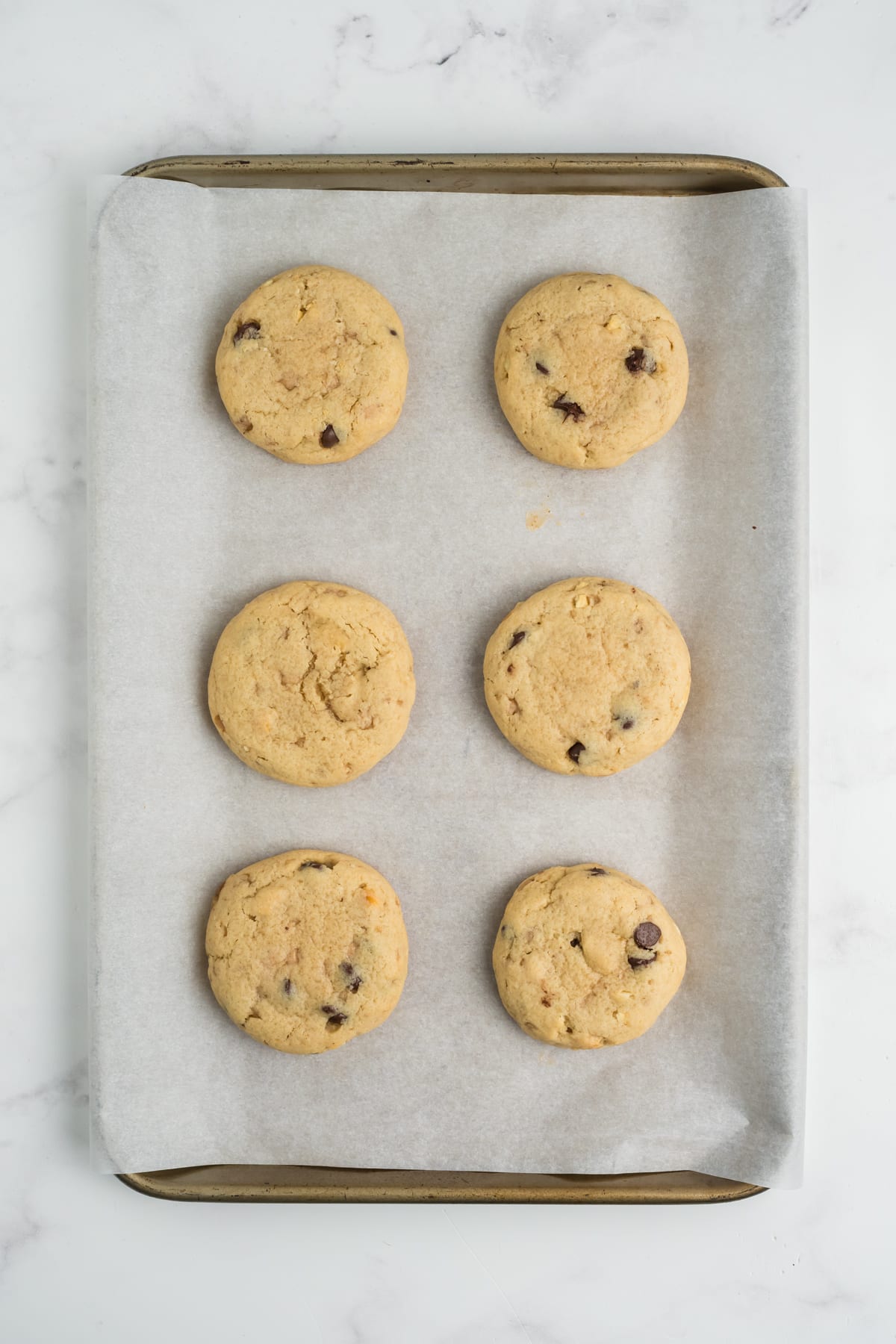 Baked crack cookies on a baking sheet.
