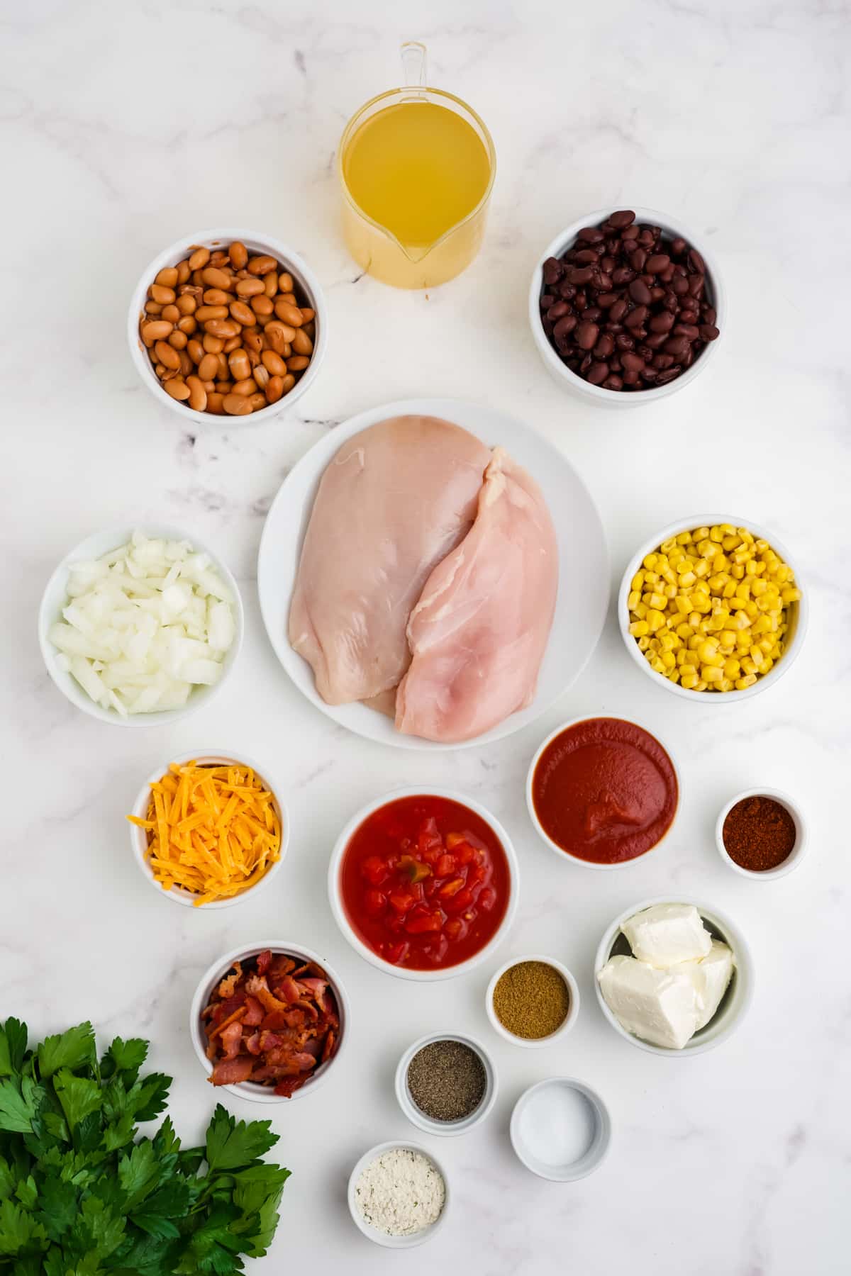 Ingredients for making this crack chicken chili in bowls.