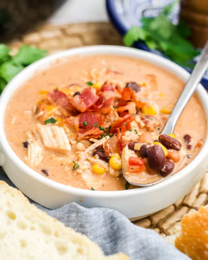 Crack chicken chili in a bowl topped with bacon.