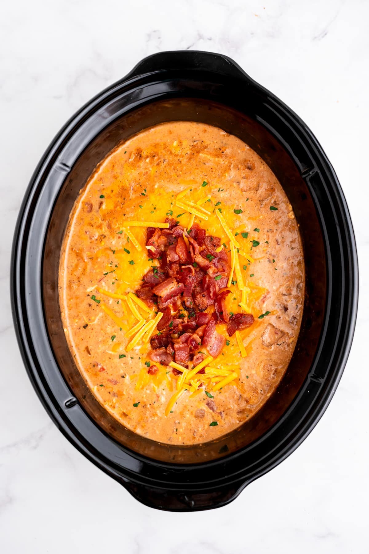 Cheddar and bacon added to the slow cooker.