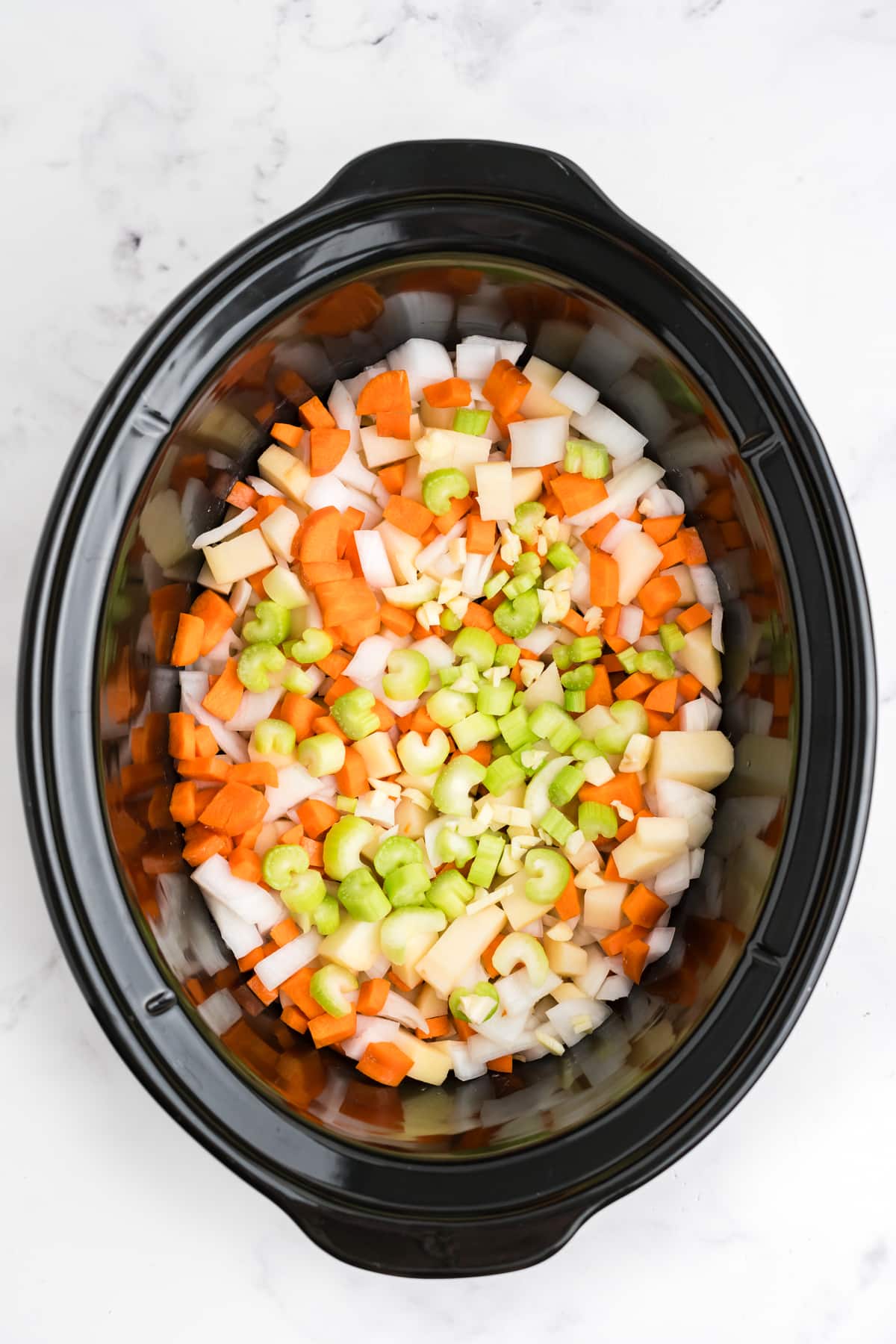 Veggies for making hamburger soup added to the crockpot.