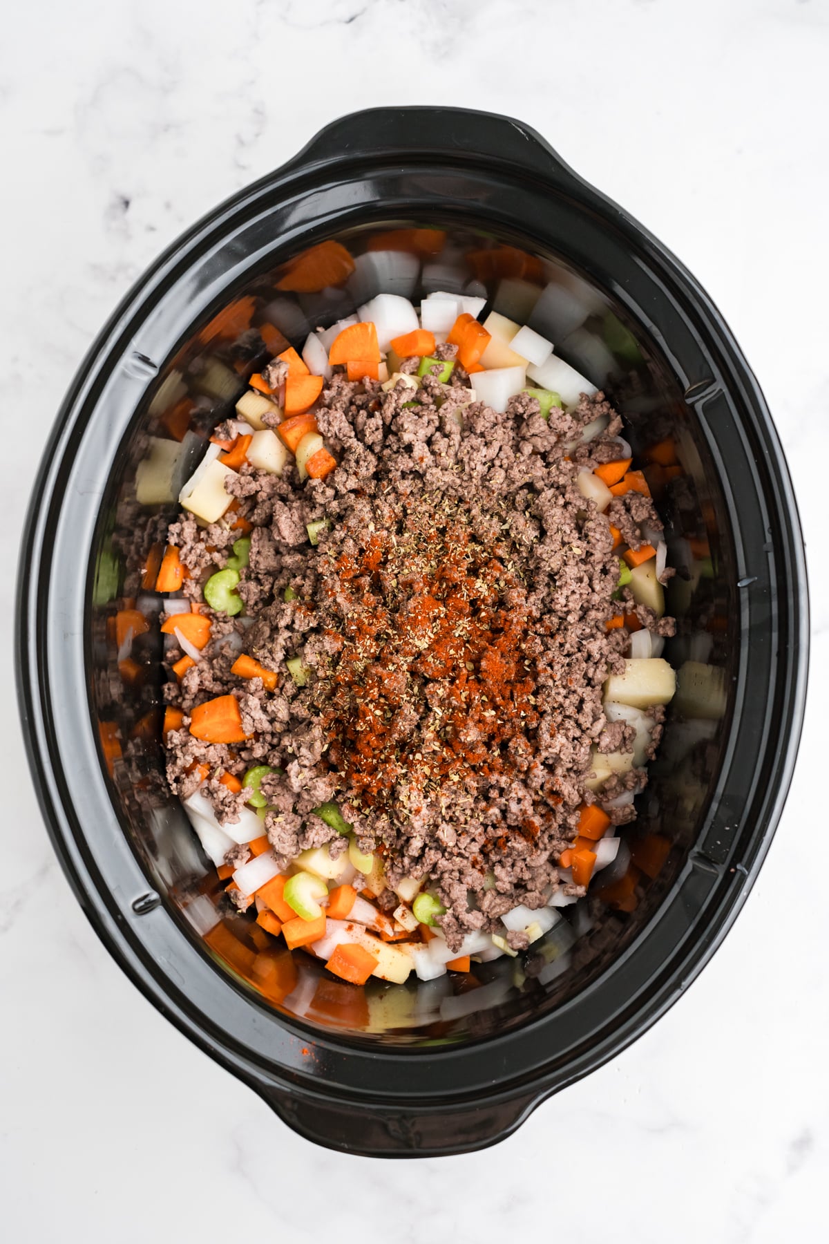 Meat and seasonings added to the crockpot.