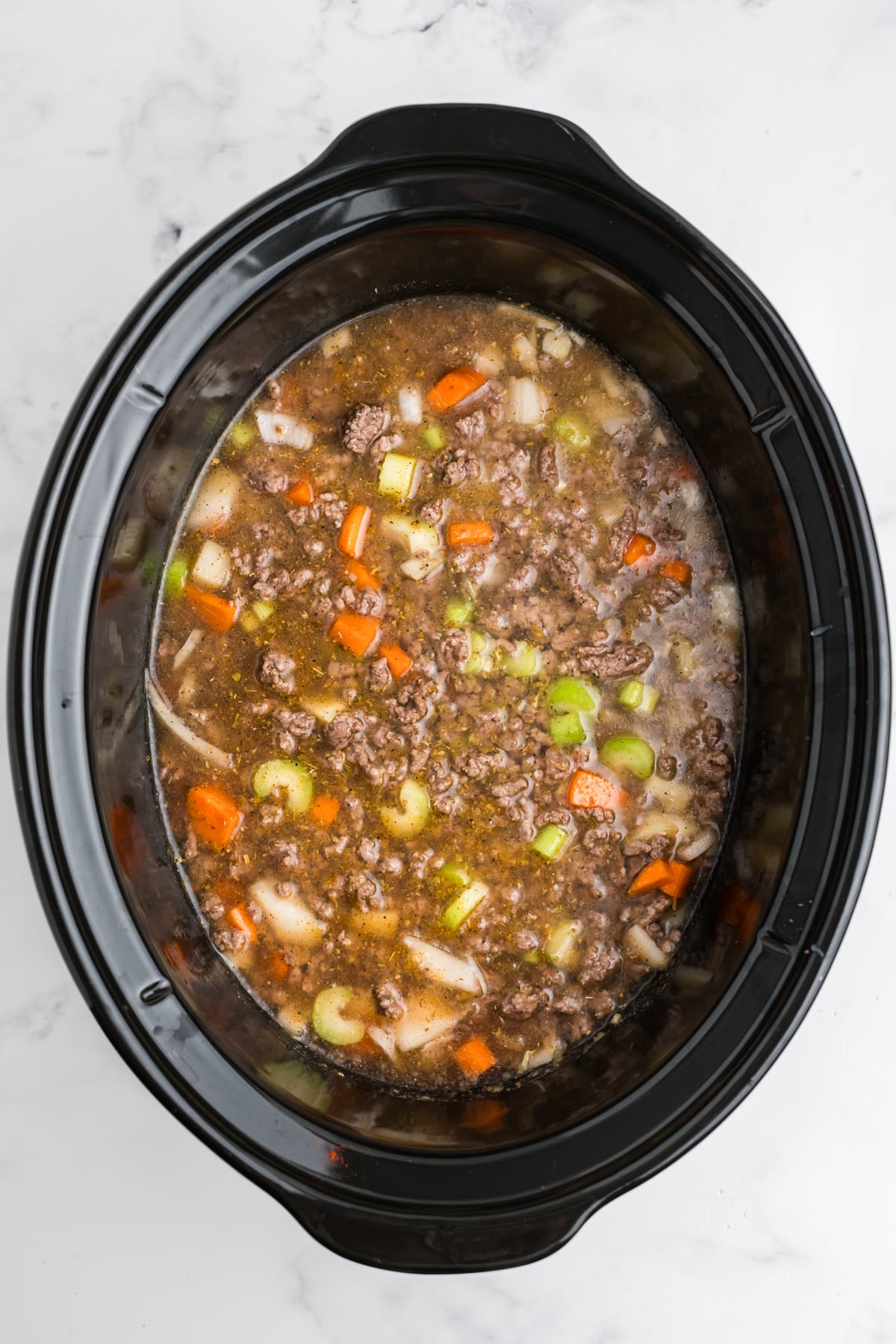 The ingredients for the hamburger soup cooked in the slow cooker.