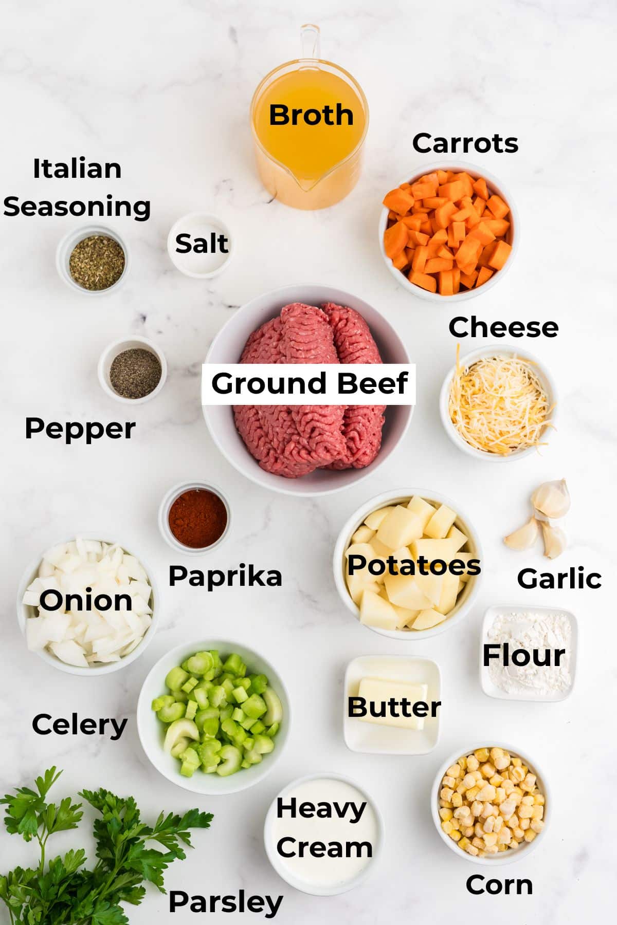 Ingredients for making creamy hamburger soup in bowls.