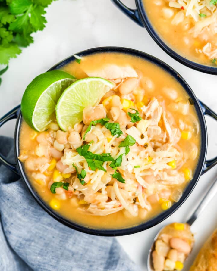 White chicken chili with corn in a soup crock with handles.