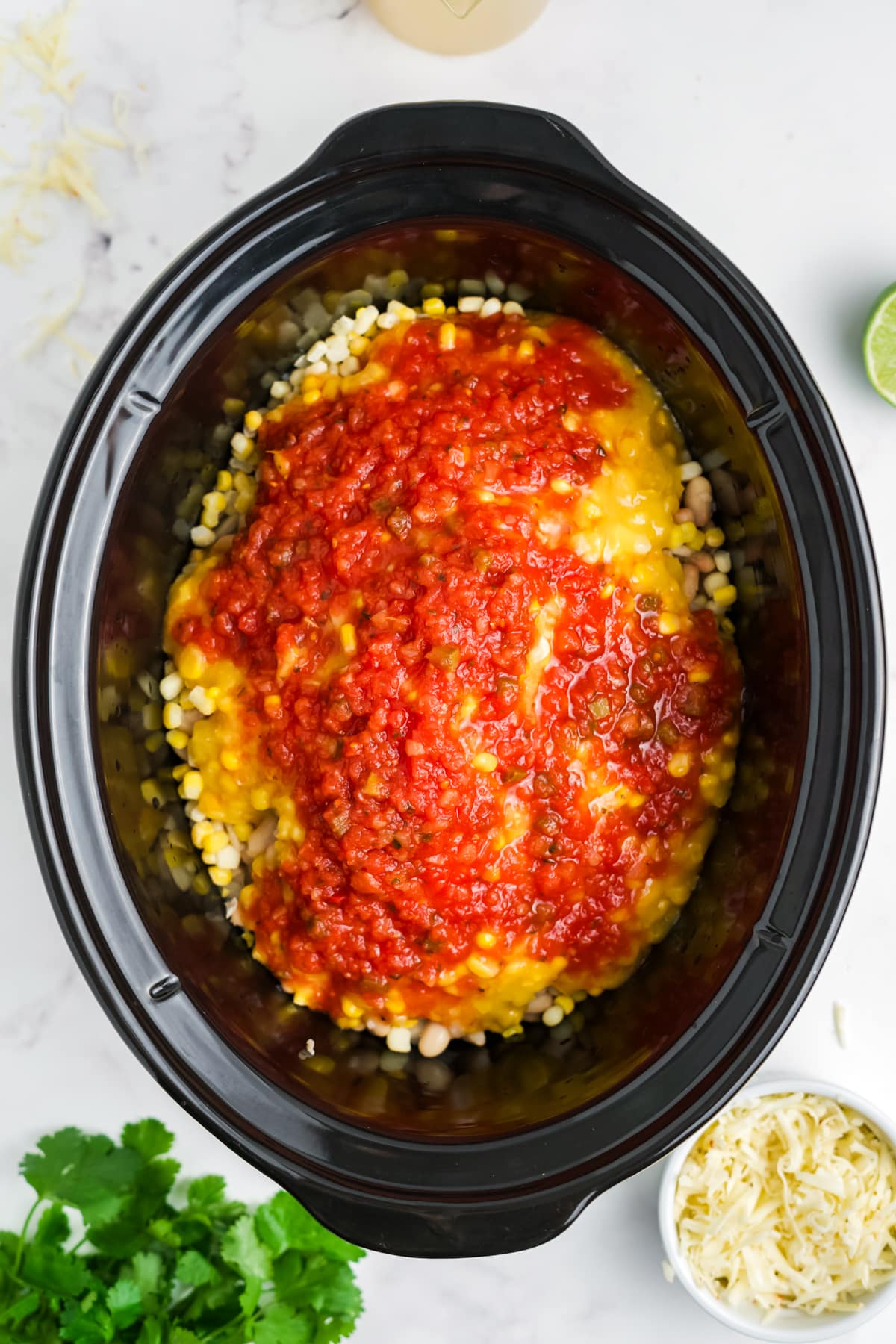 Beans, corn and salsa added to the slow cooker.