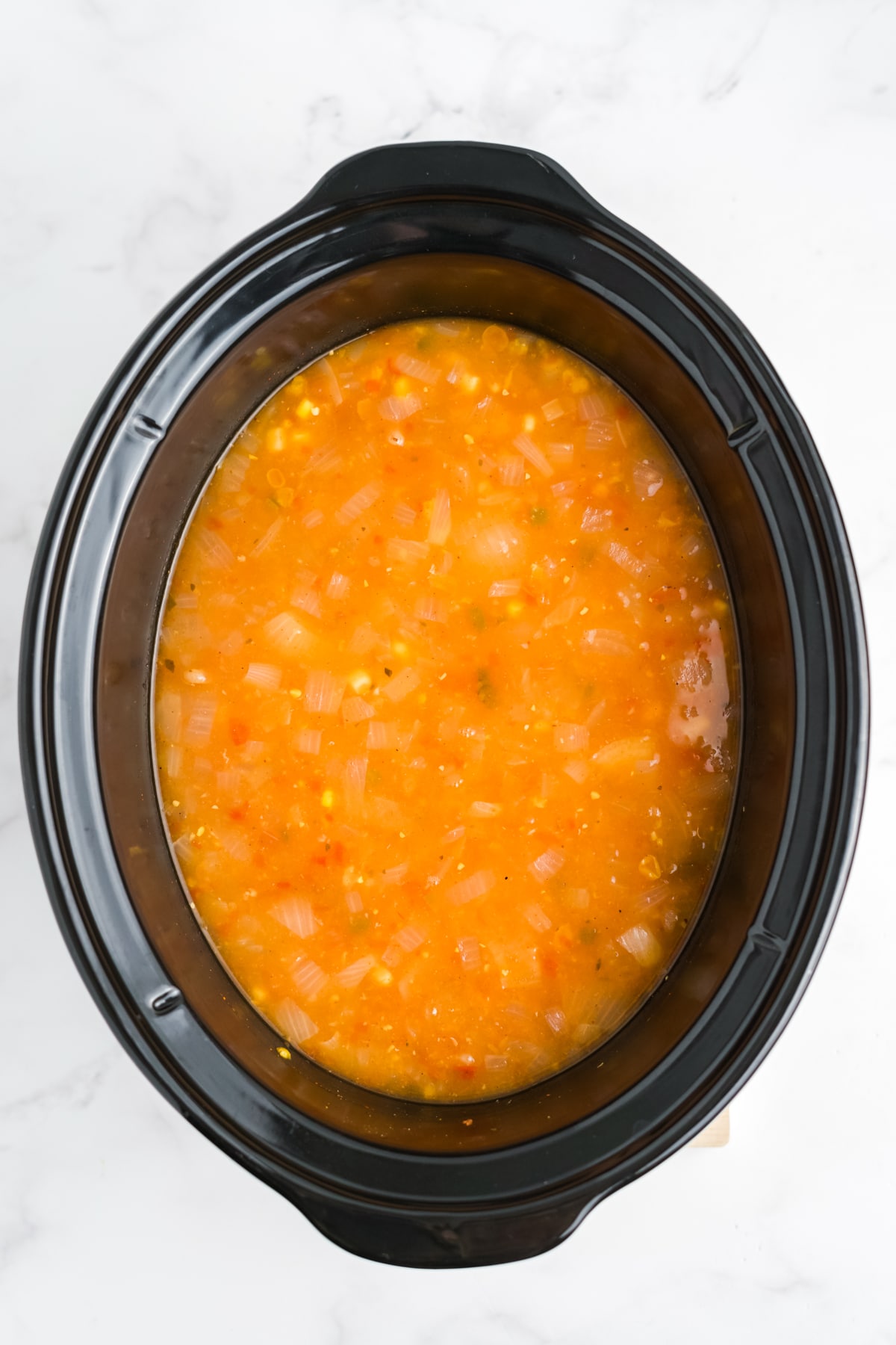 Broth added to the slow cooker.