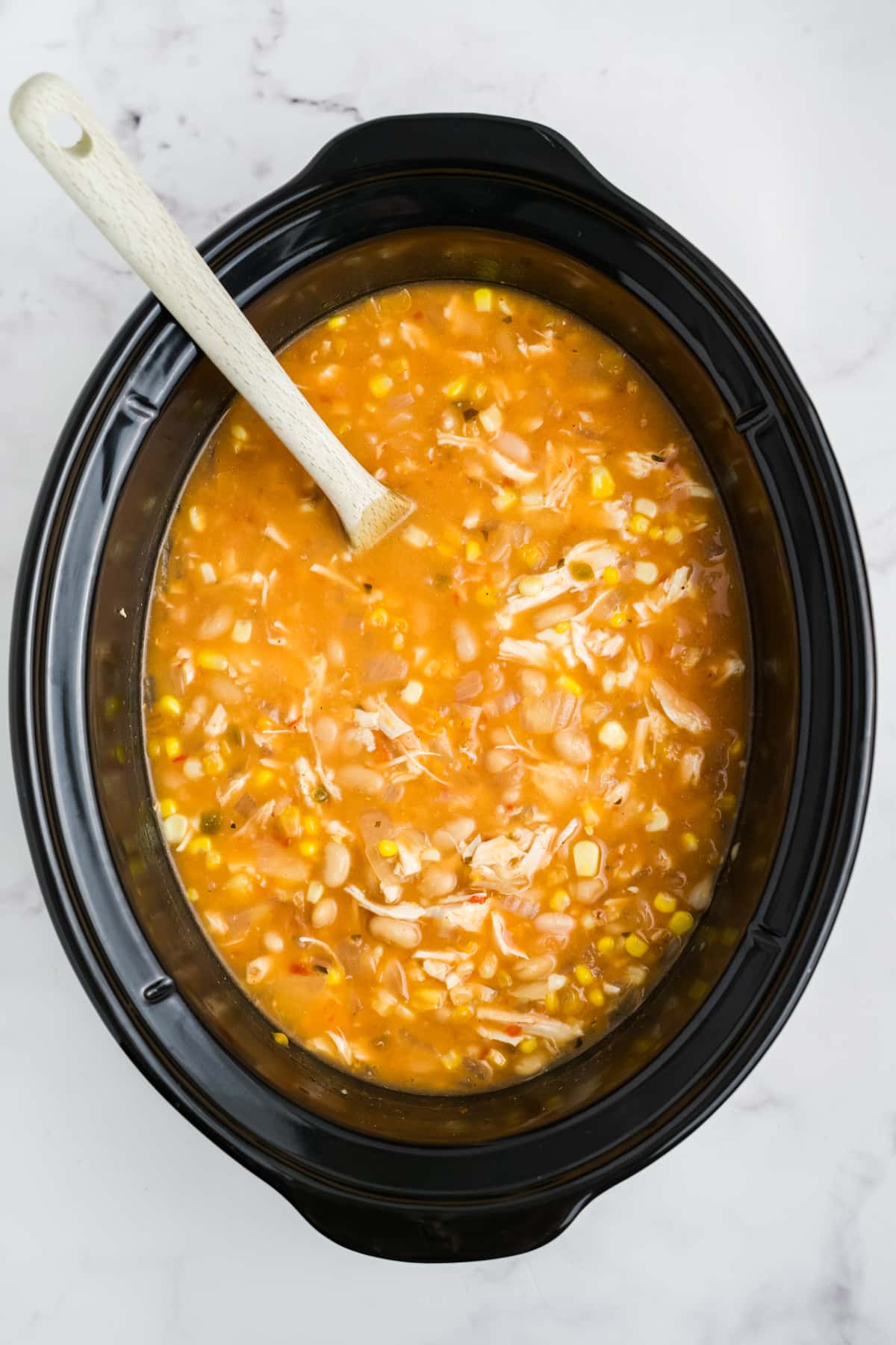 Cooked white chicken chili in the slow cooker.