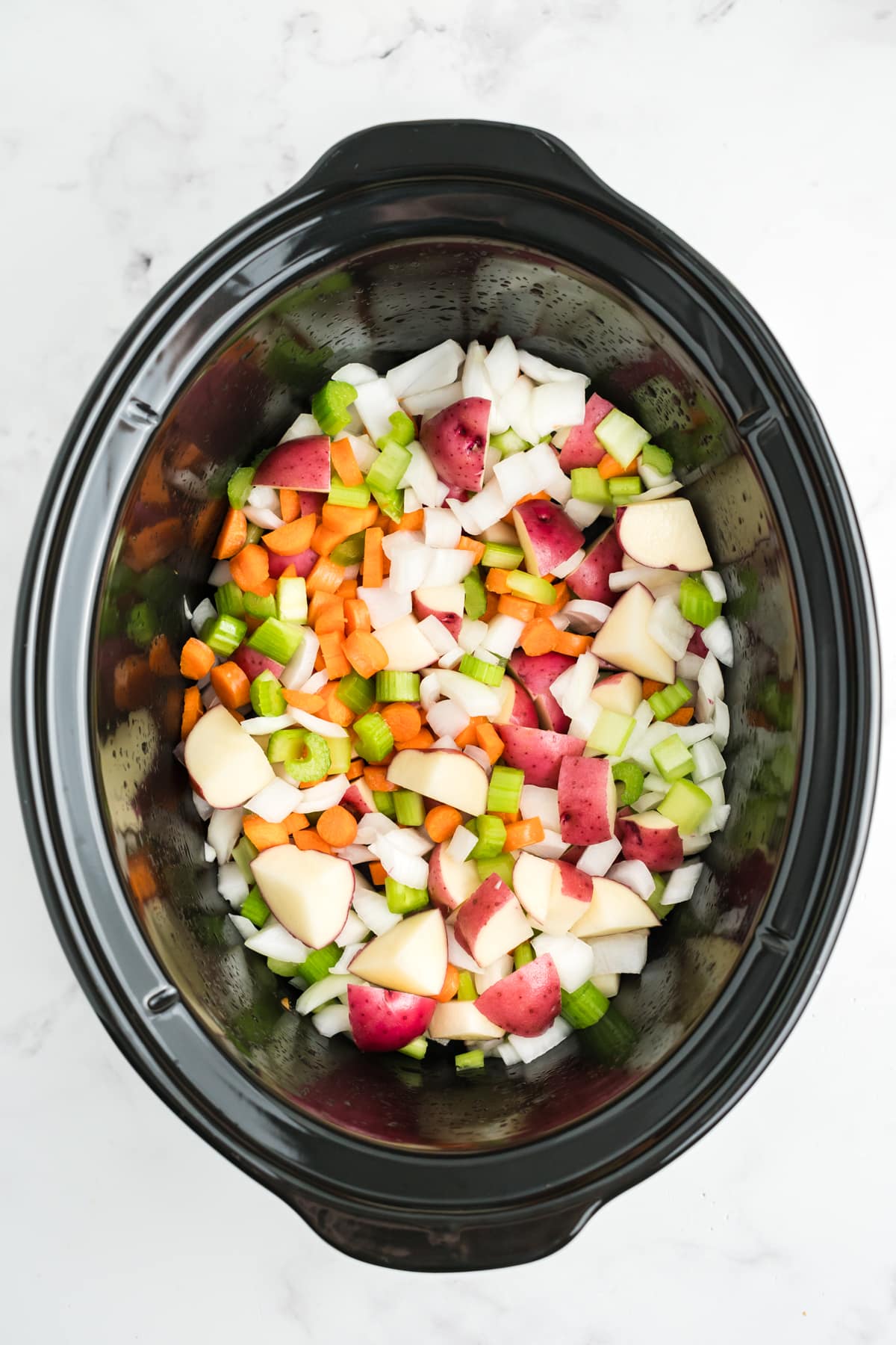 Vegetables added to the crockpot. 