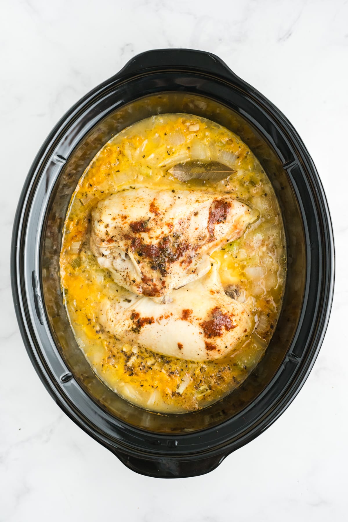 Cooked chicken and sauce in the slow cooker. 