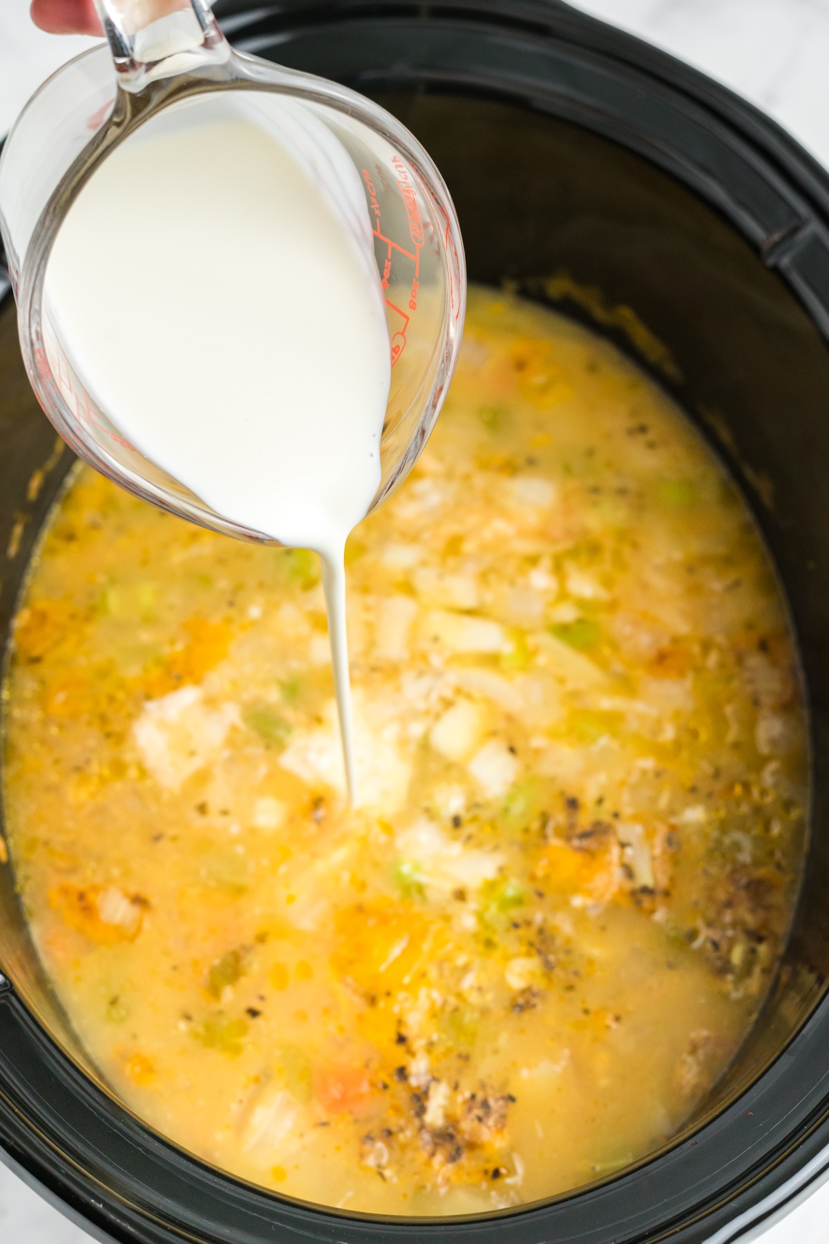 Cream added to the slow cooker. 