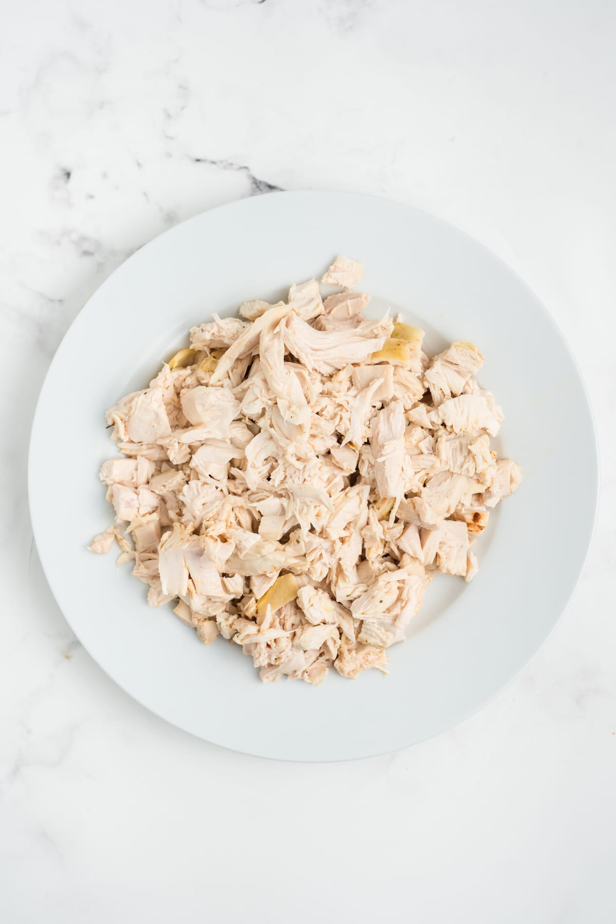 Chicken shredded on a plate. 