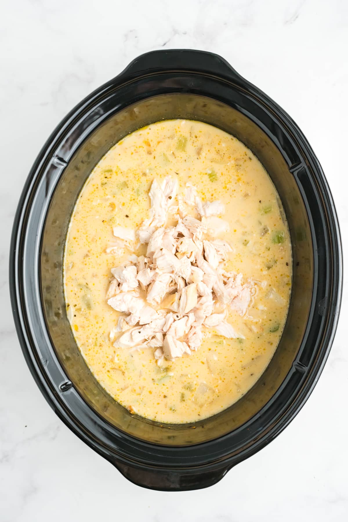 Chicken added back to the stew in the crockpot. 