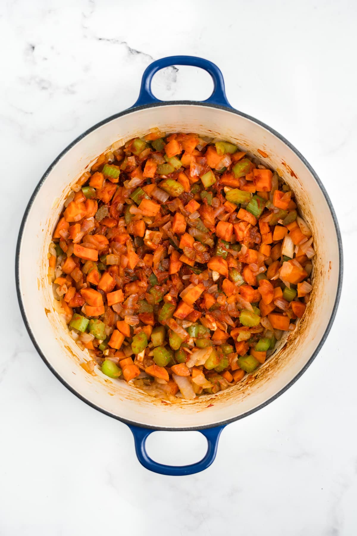 Tomato paste added to the pot with the beef and veggies.