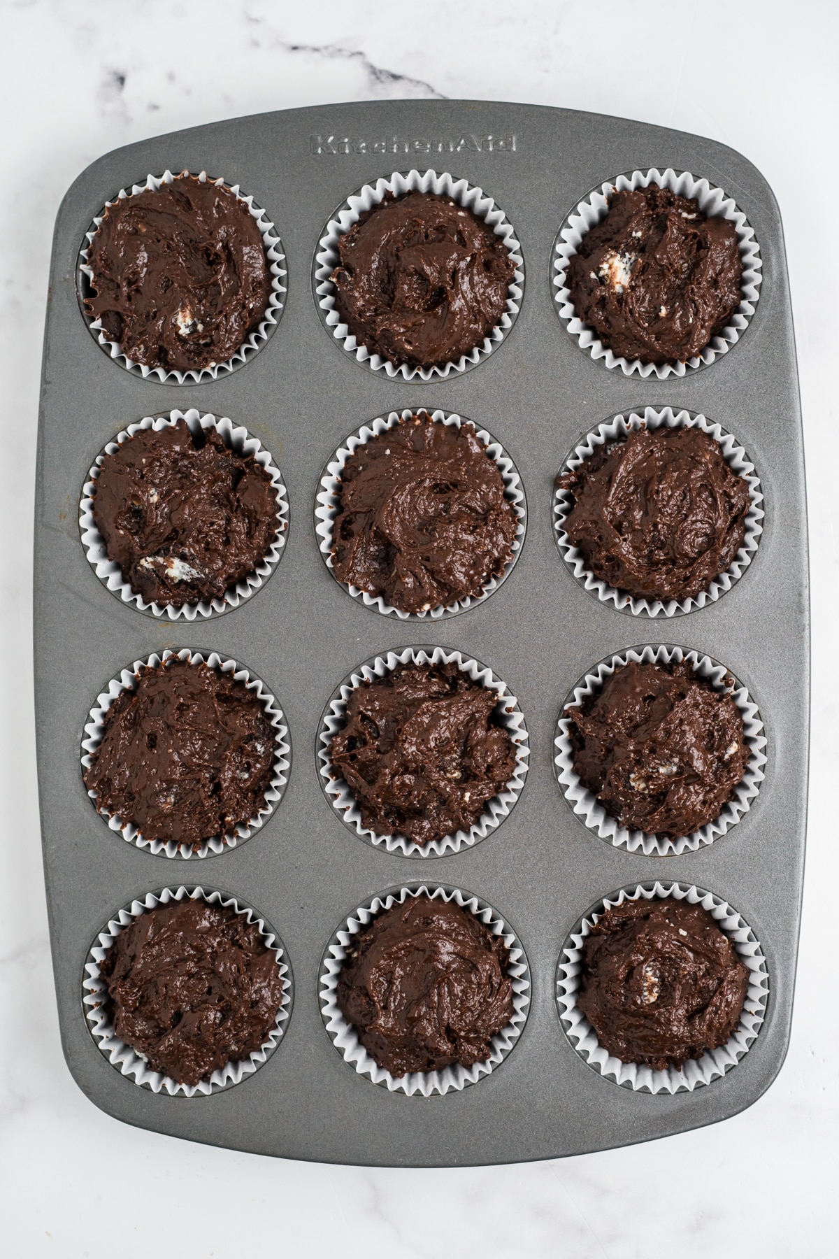 Muffin batter added to the muffin tin.