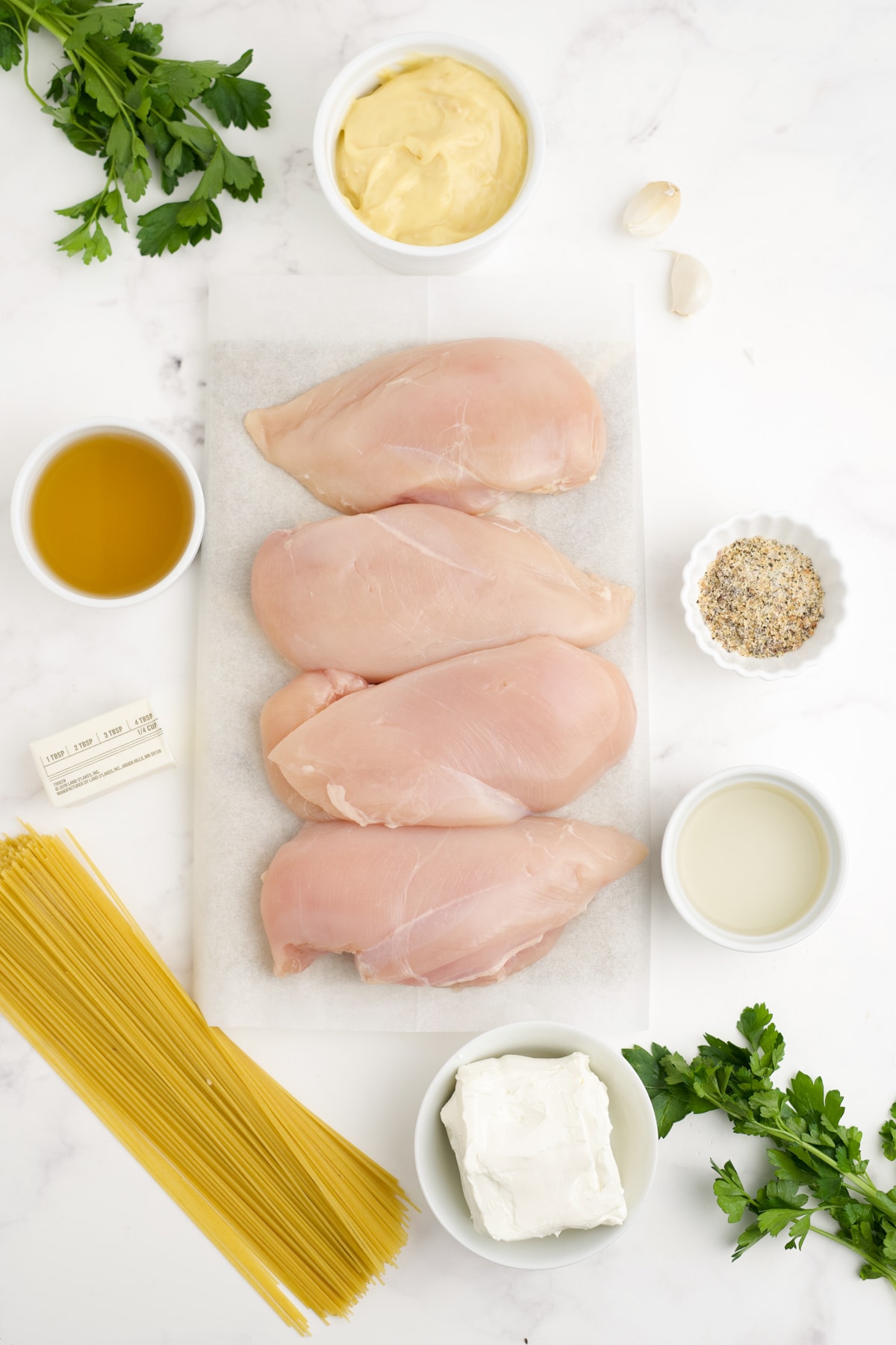 Ingredients to make angel pasta chicken on a counter top before preparing. 