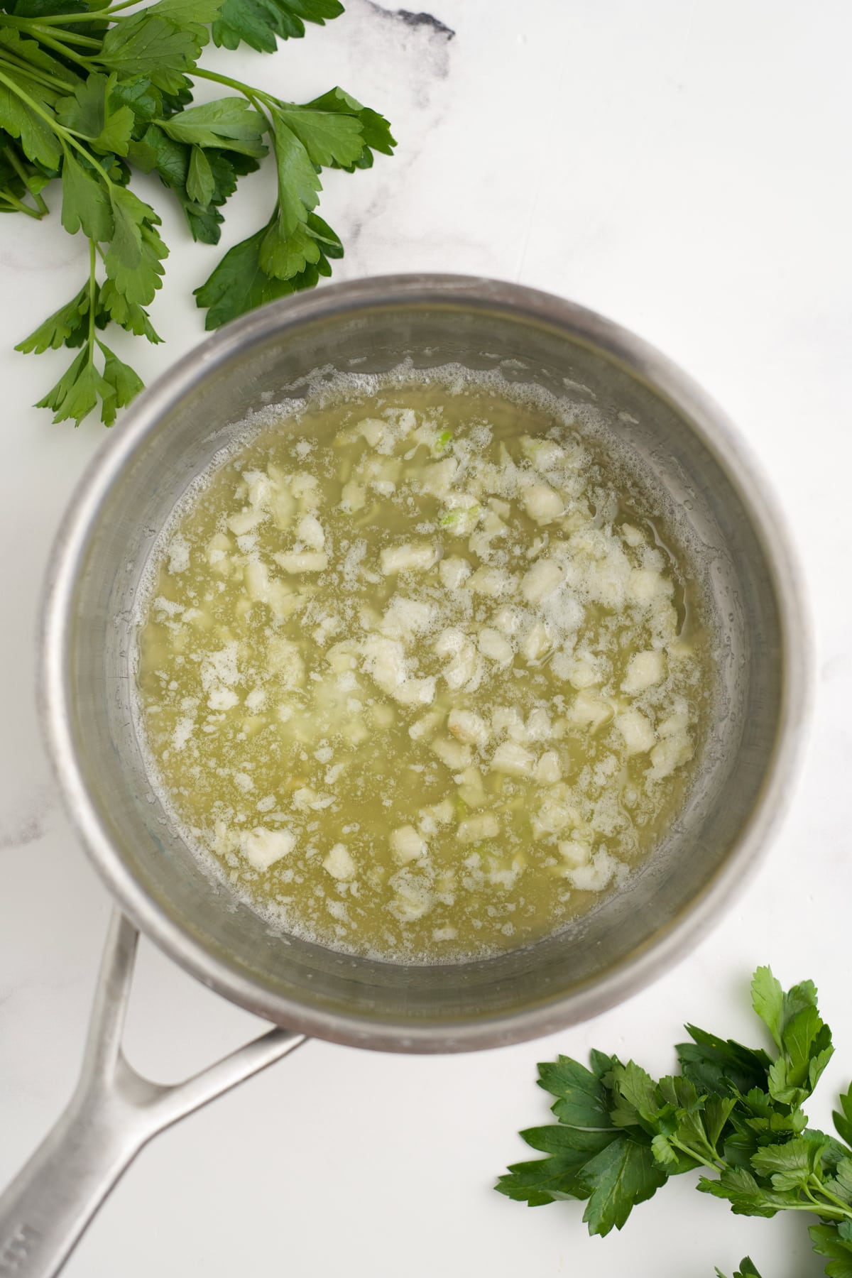 Garlic cooking in butter in a skillet. 