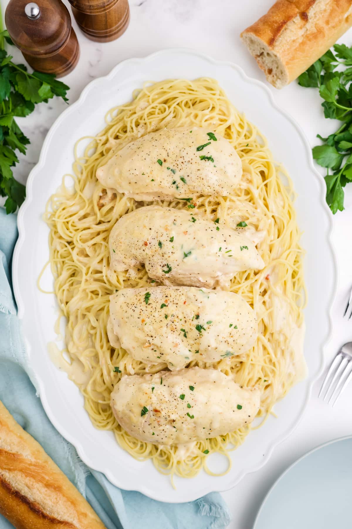 Angel chicken breasts served pasta on a platter. 