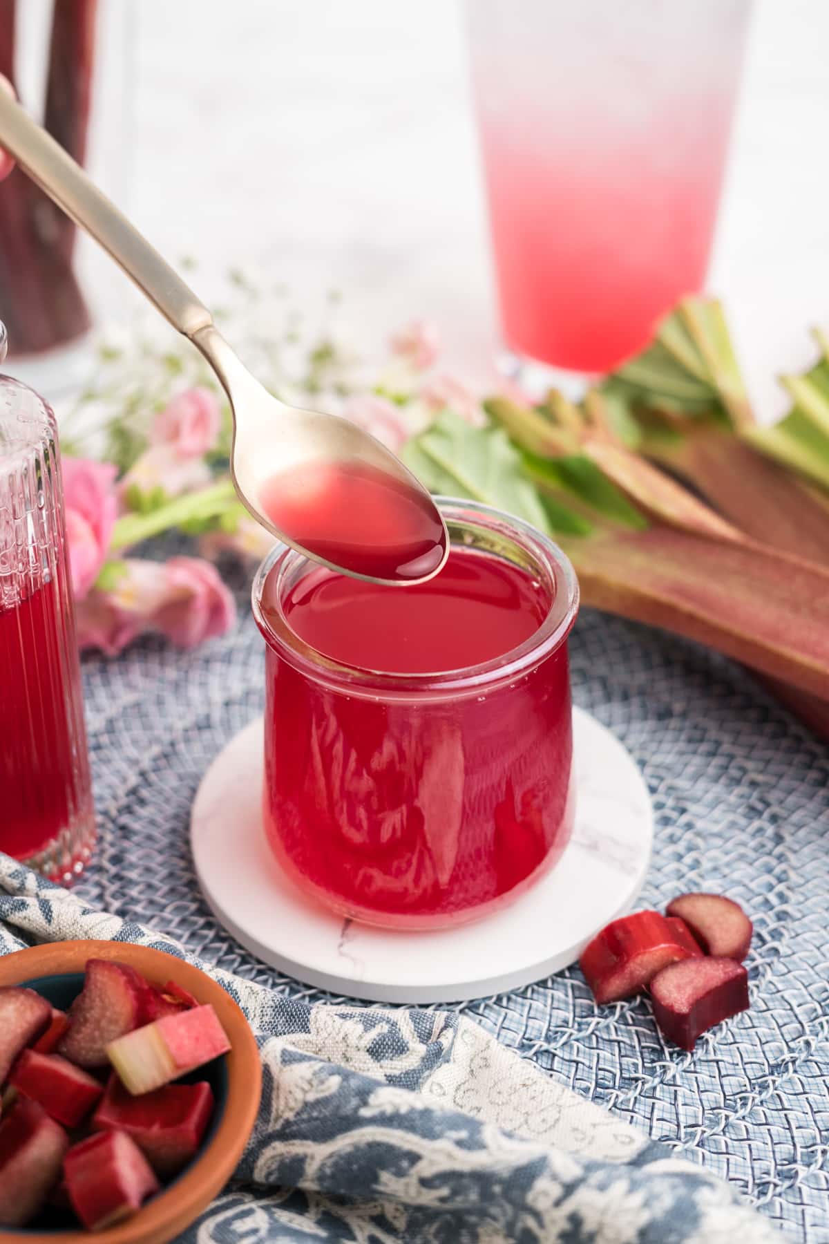 Rhubarb Simple Syrup being spooned into a jar. 