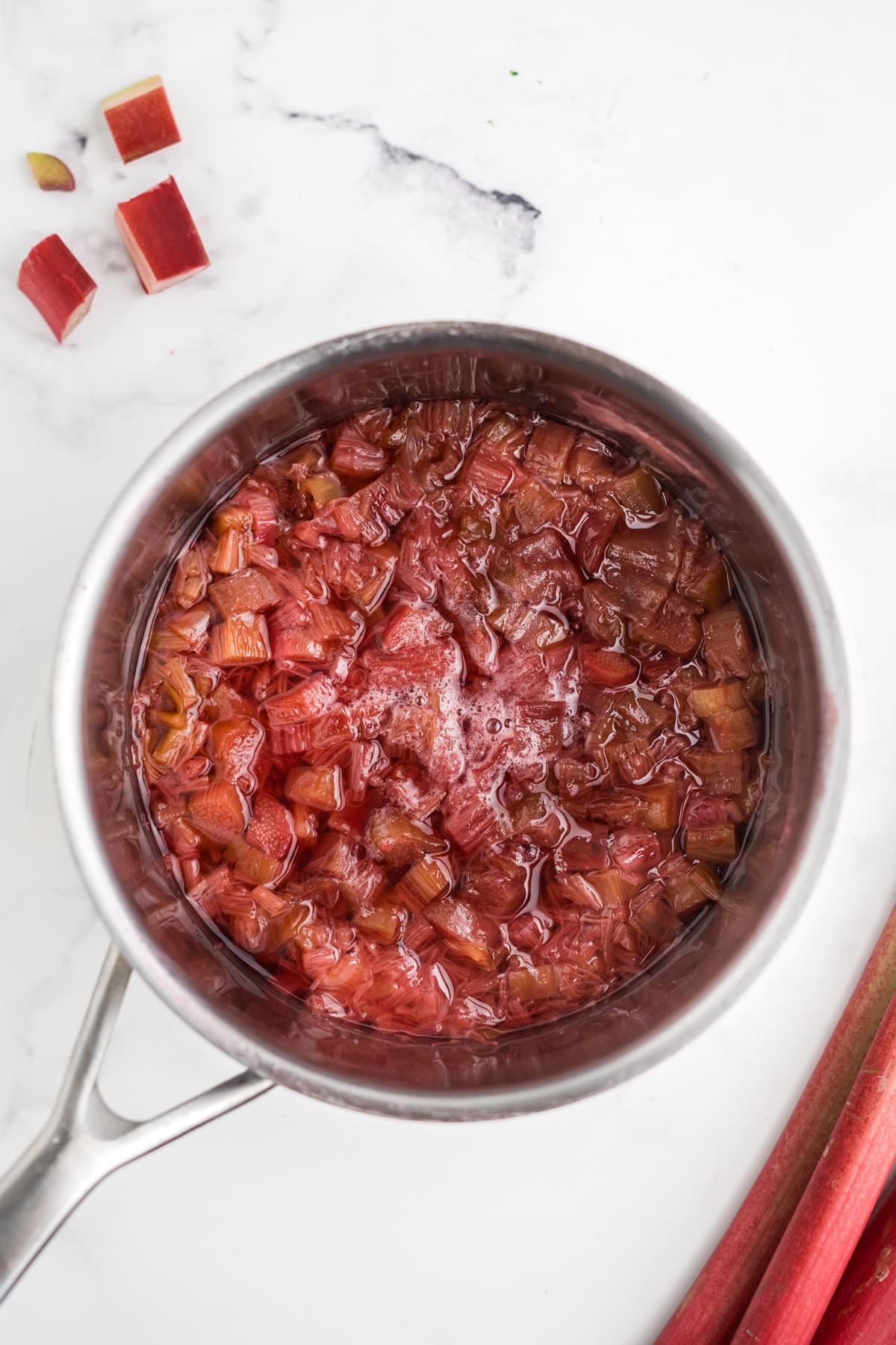 An overhead image of cooked rhubarb and sugar.