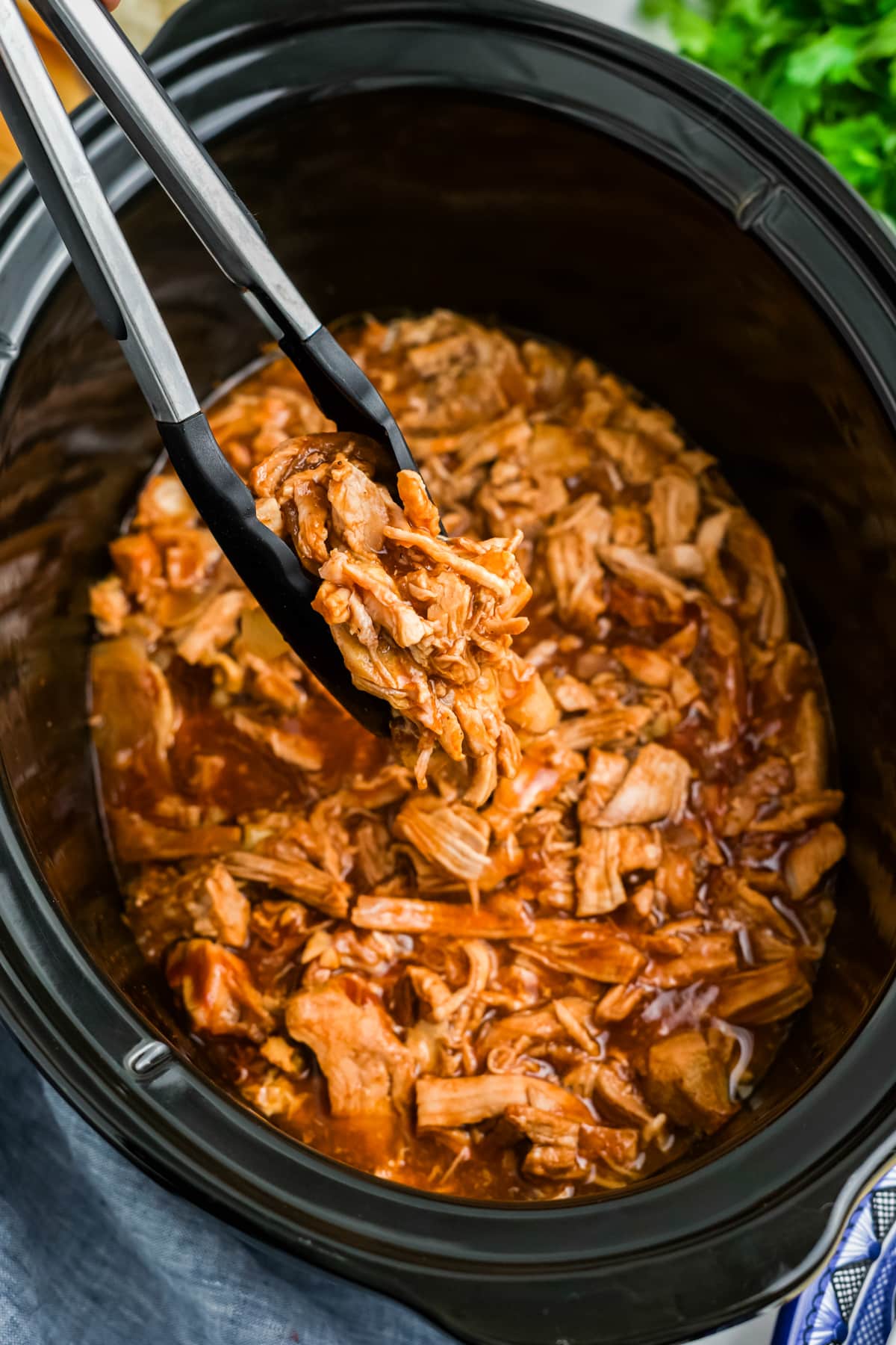 Shredded bbq pork tenderloin in a slow cooker.