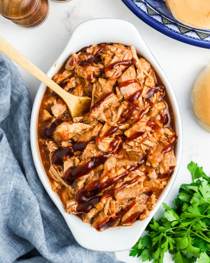 Pulled pork tenderloin in a serving dish.
