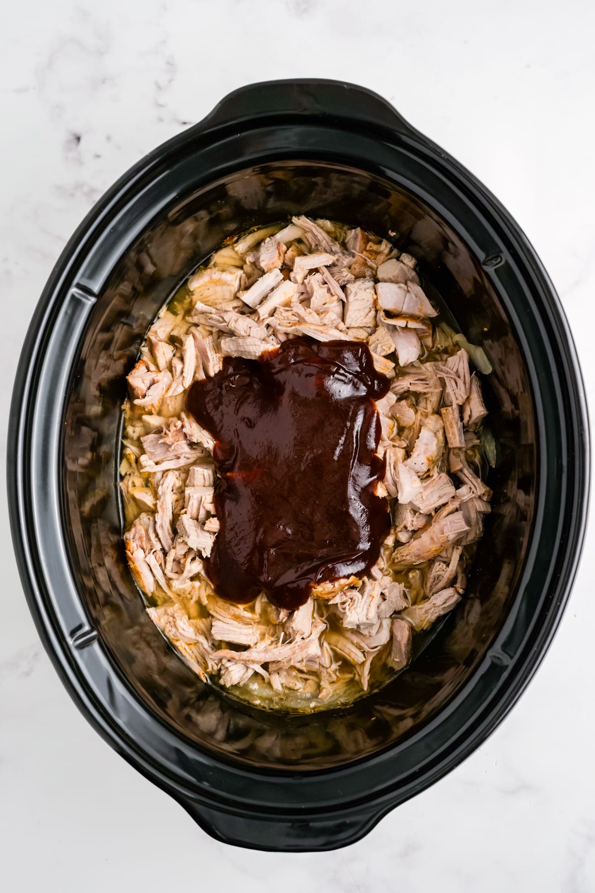 BBQ sauce and pulled pork in a slow cooker.