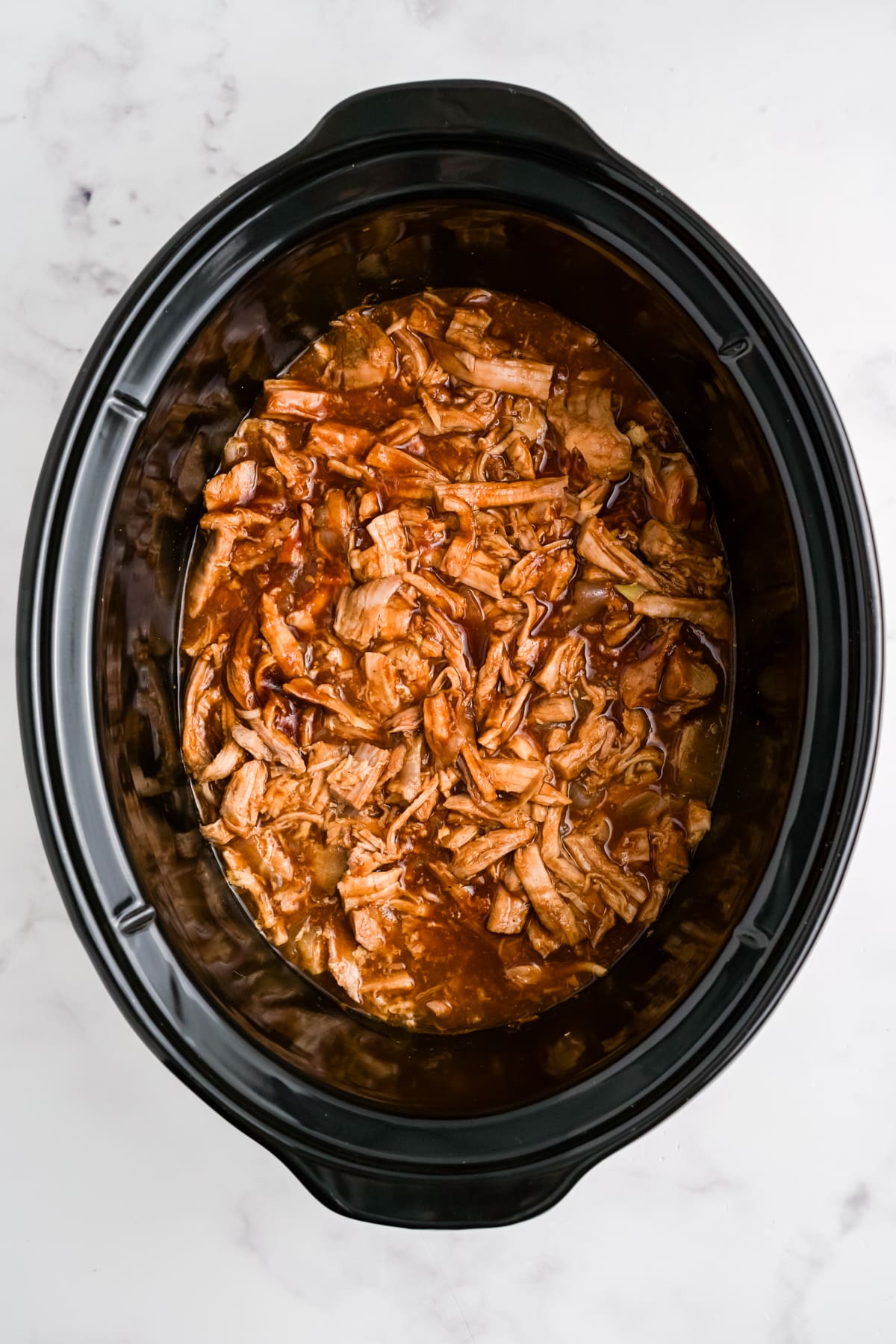 BBQ shredded pork in a slow cooker.