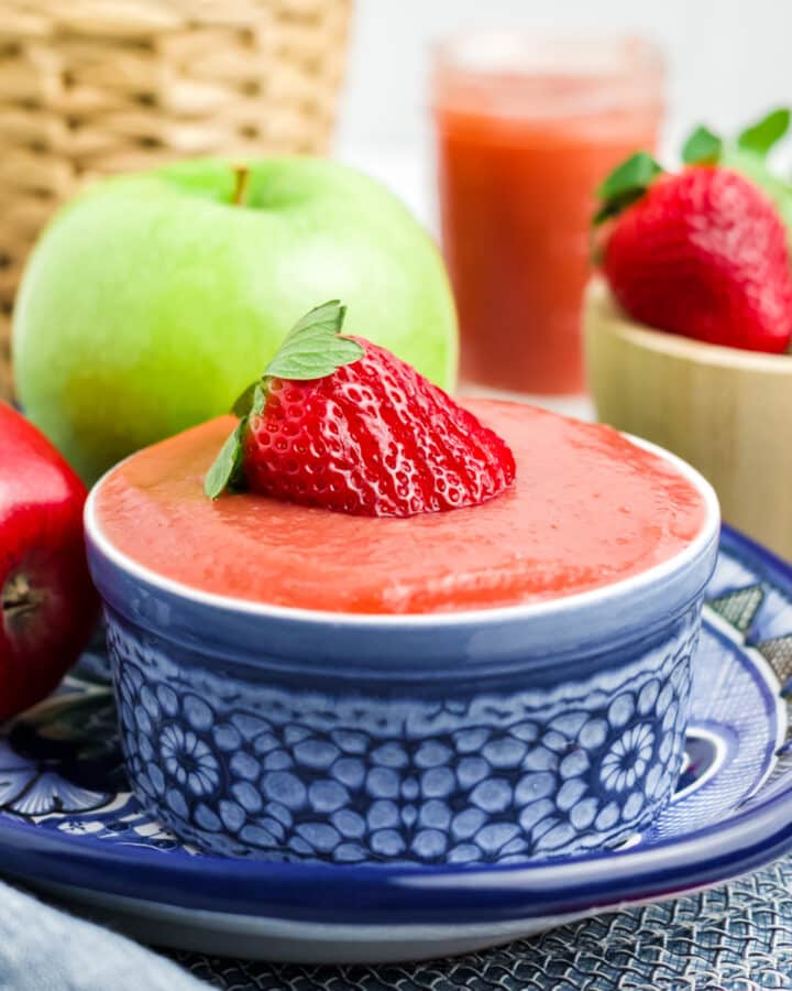 Strawberry applesauce in a blue and white bowl.