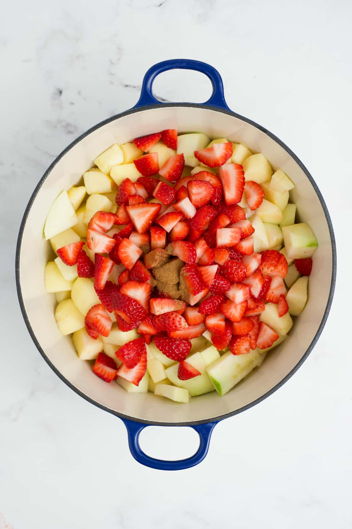 Cut up fruit added to a pot.