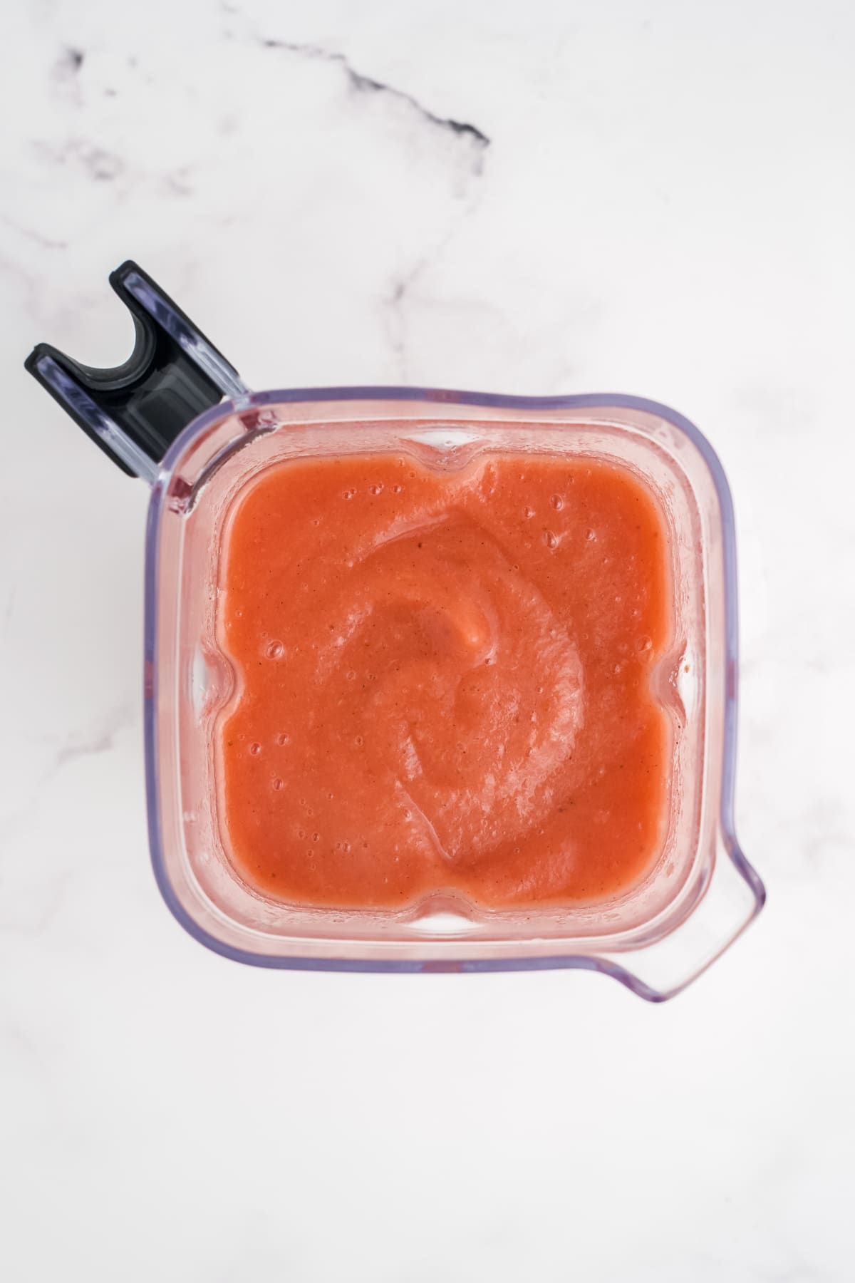 Blended strawberry applesauce in a blender.