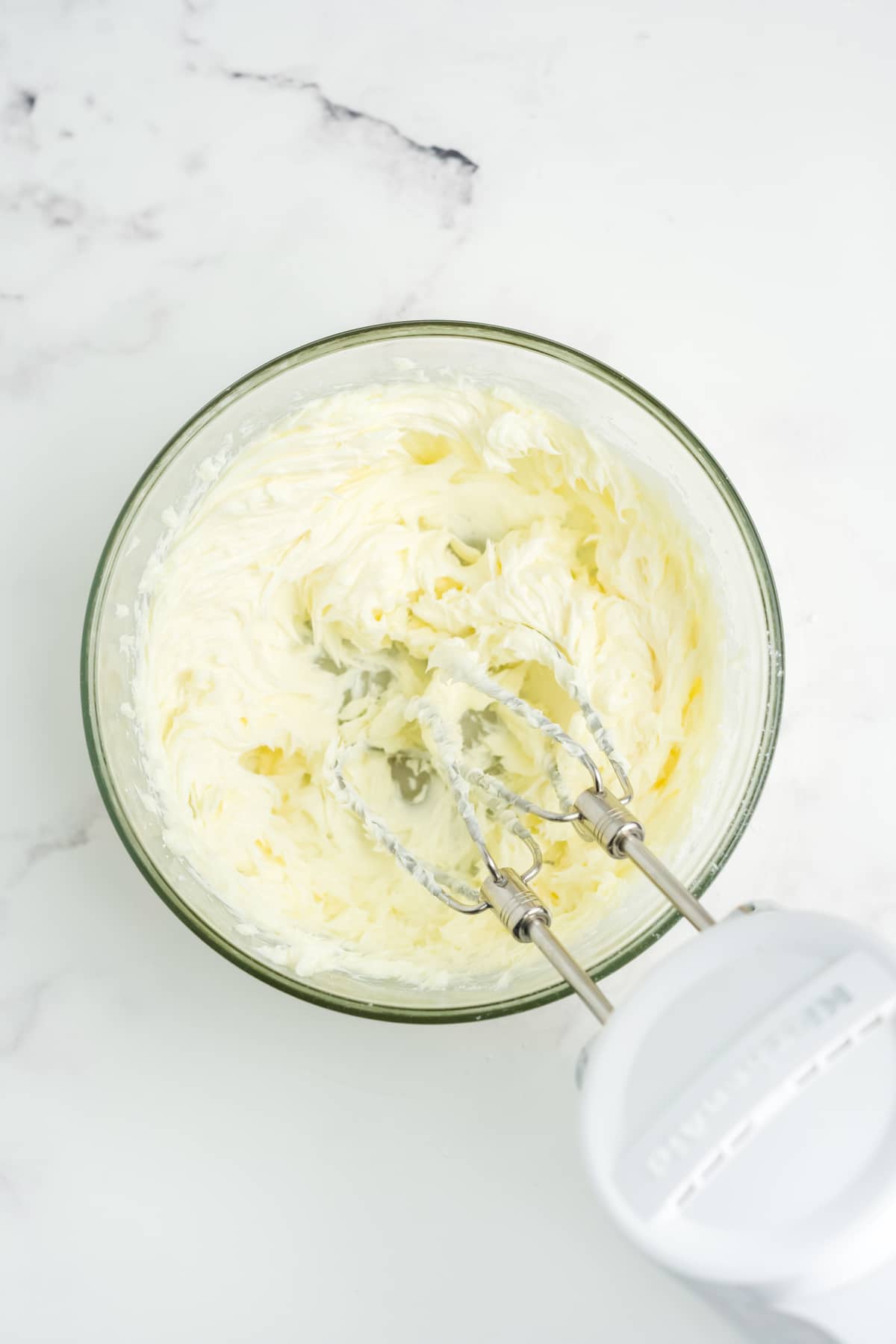 All of the ingredients being beat together with a mixer.
