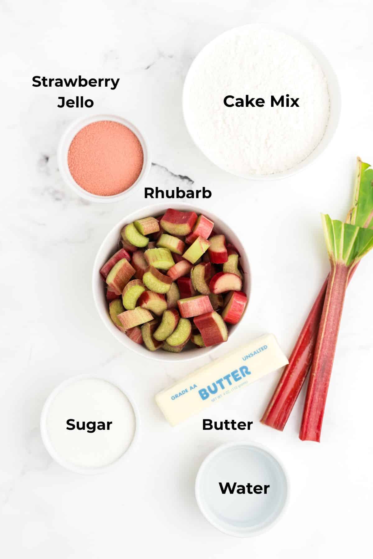 Ingredients to make rhubarb dump cake on a table in bowls. 