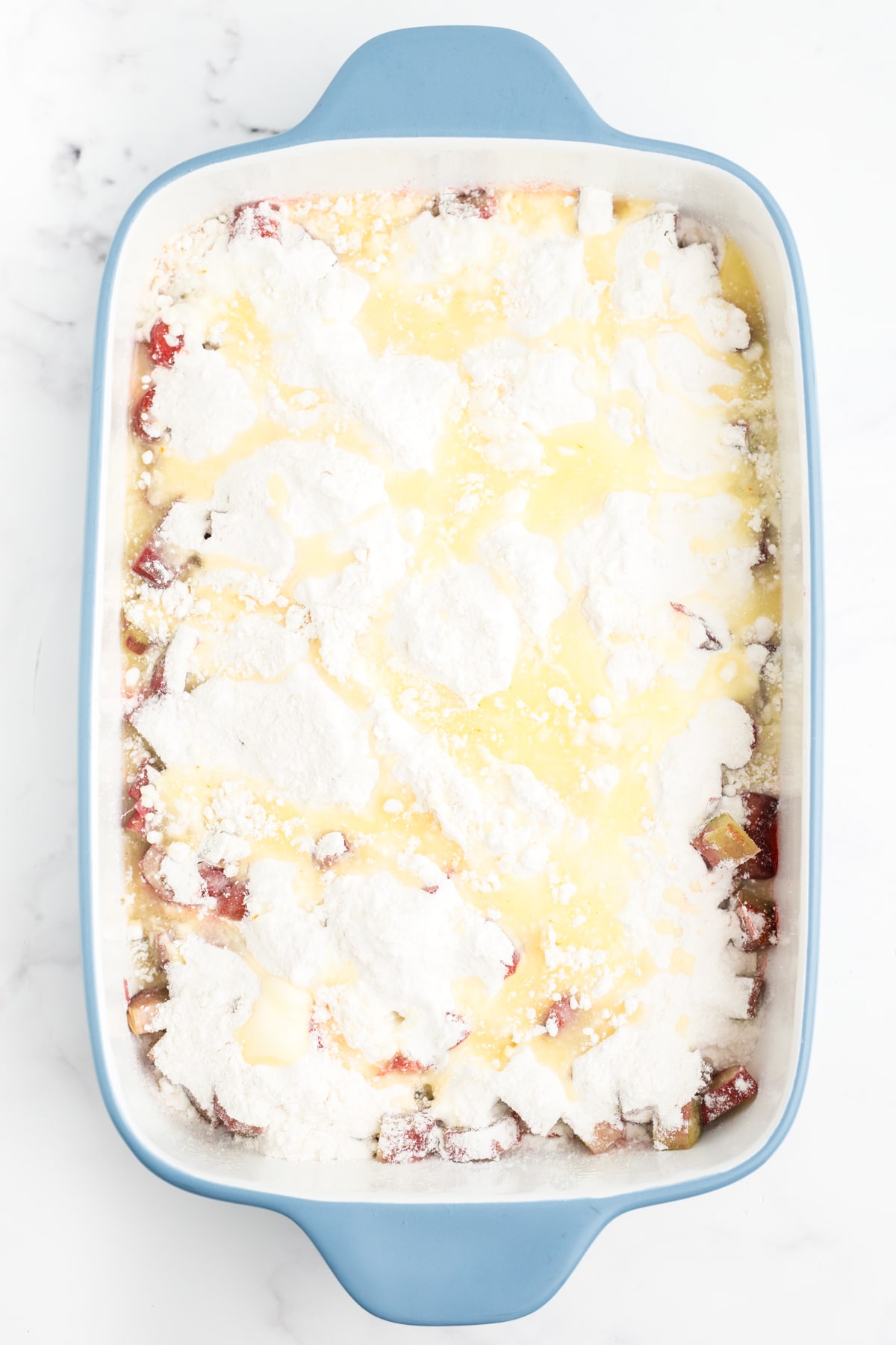 Butter added on top of the rhubarb dump cake. 