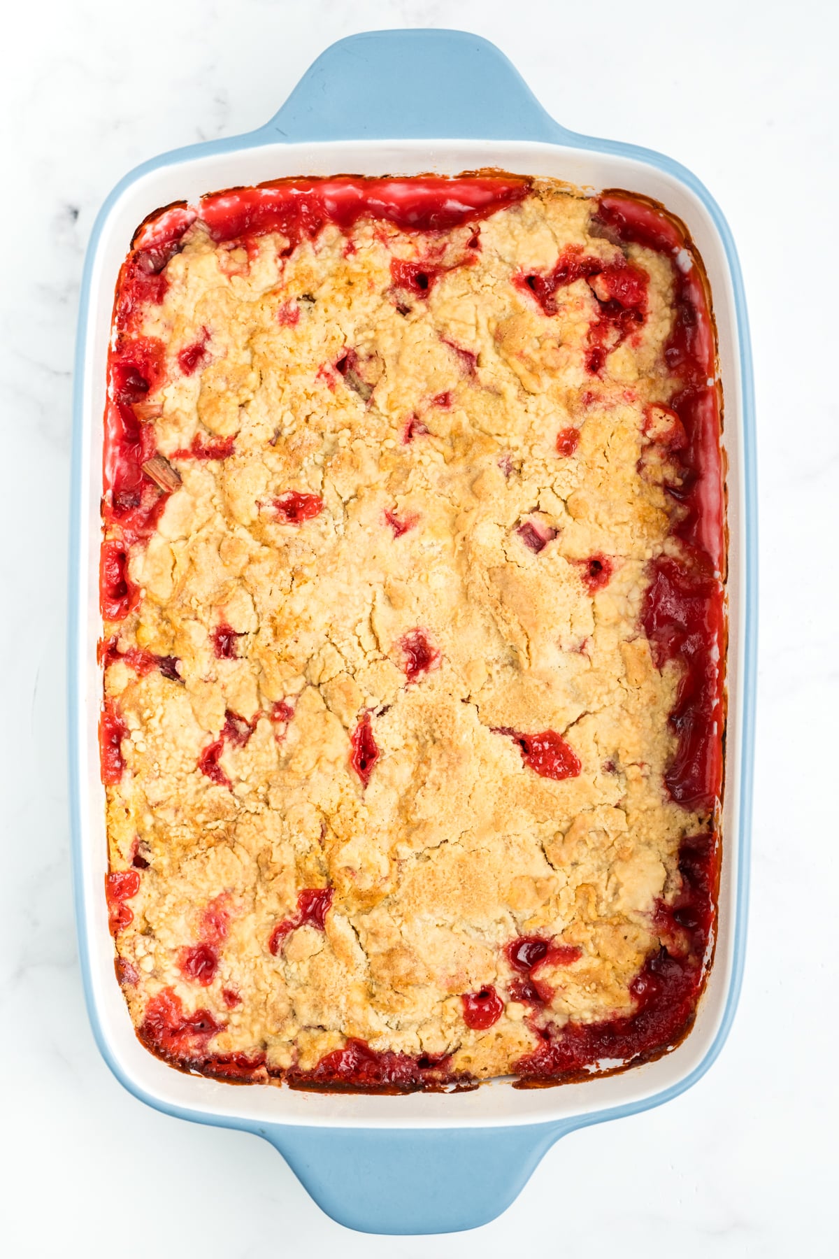 Rhubarb dump cake baked in a rectangle baking dish. 